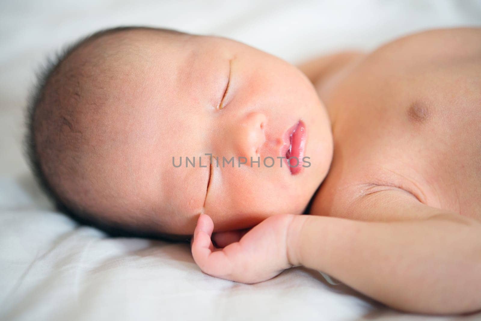 Sleeping Asian newborn baby boy, 1 week old.