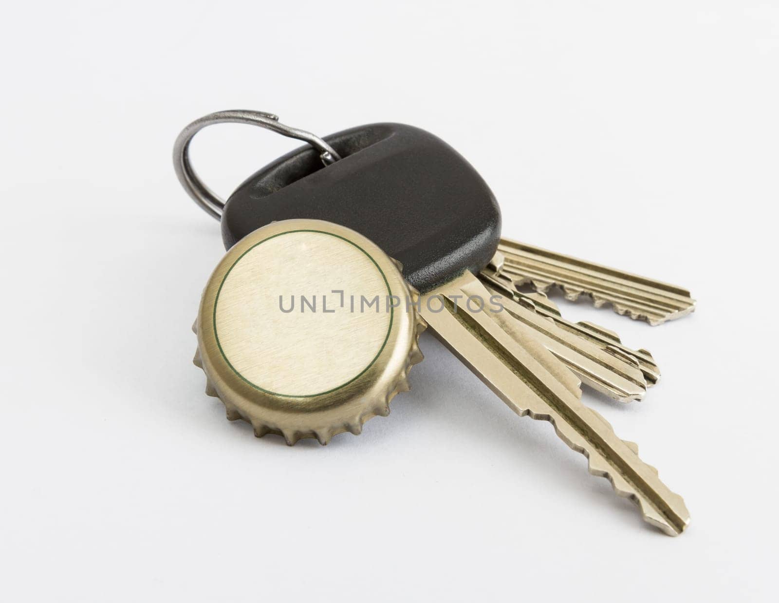 car key and bottle cap in close up with neutral grey background
