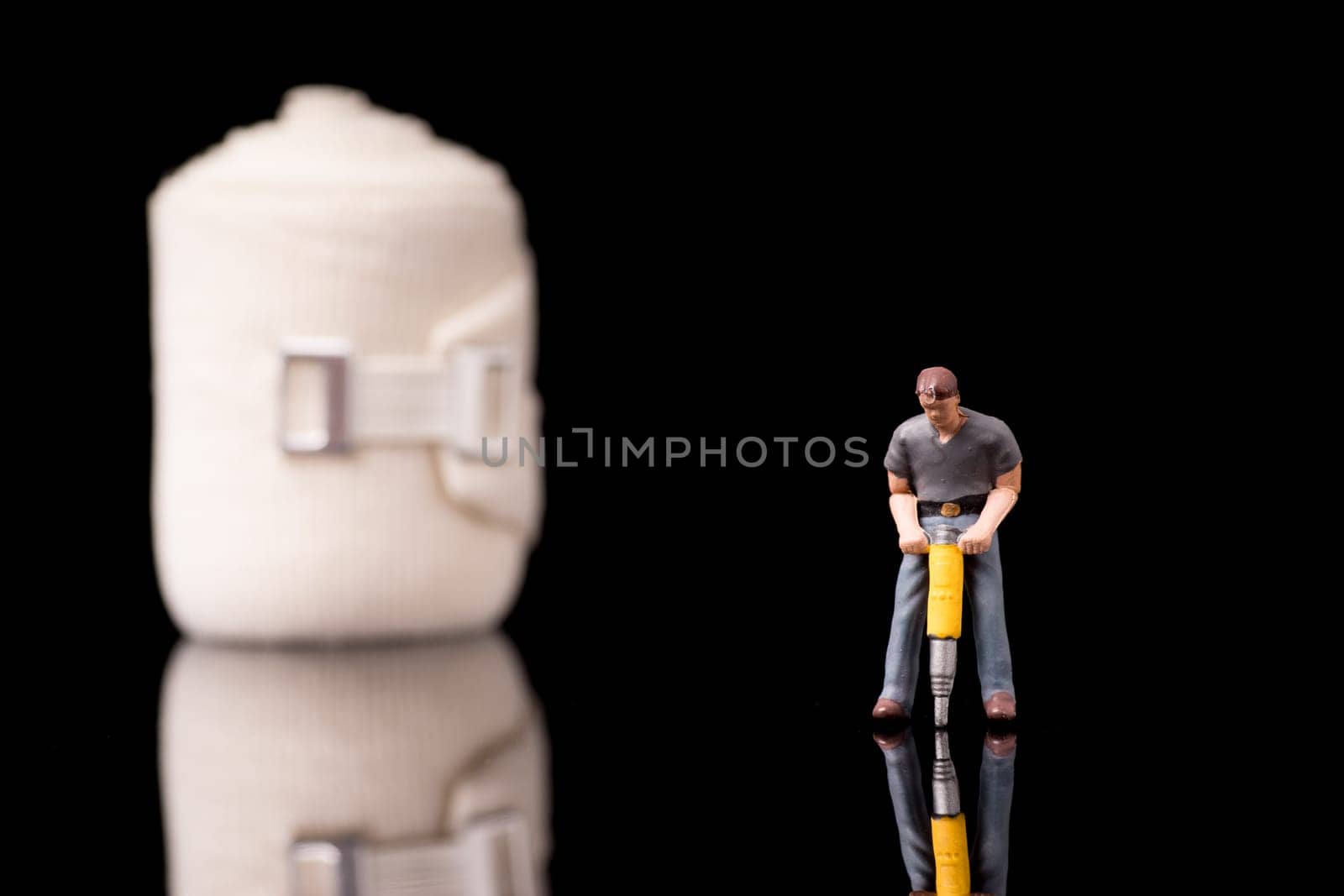Bandage used for injuries during work, leisure time or in housework, isolated on glossy black background