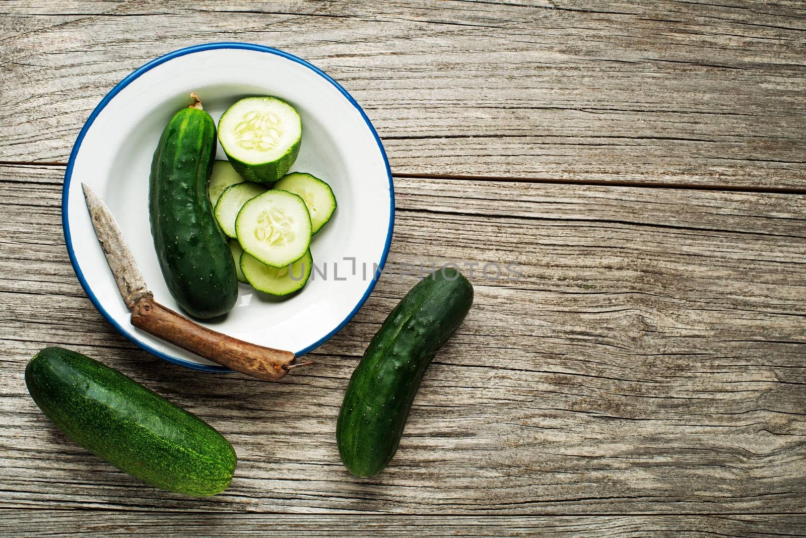 Fresh green cucumber sliced prepare for meal on wooden background