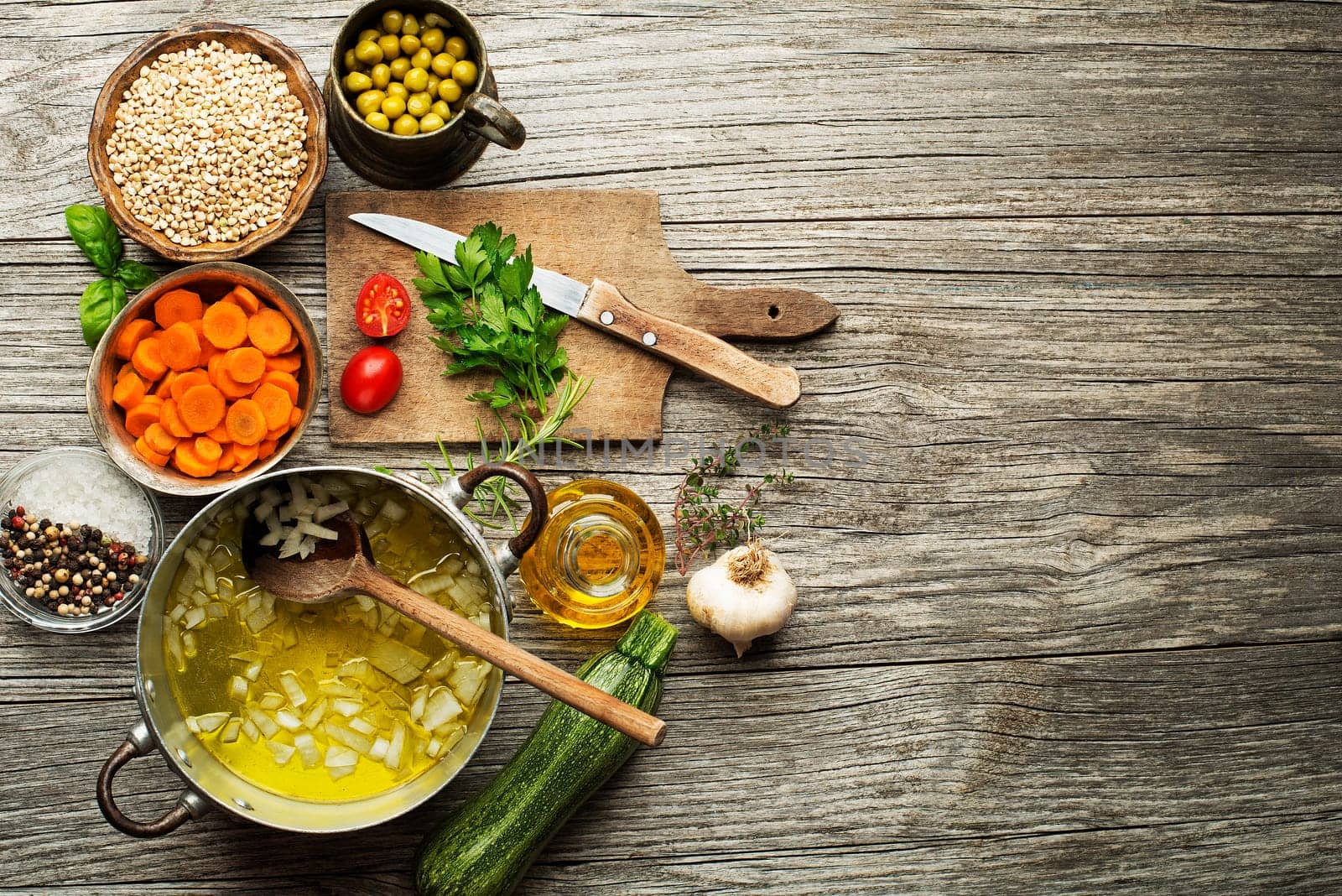 Ingredients for cooking fresh buckwheat porridge meal on wooden background