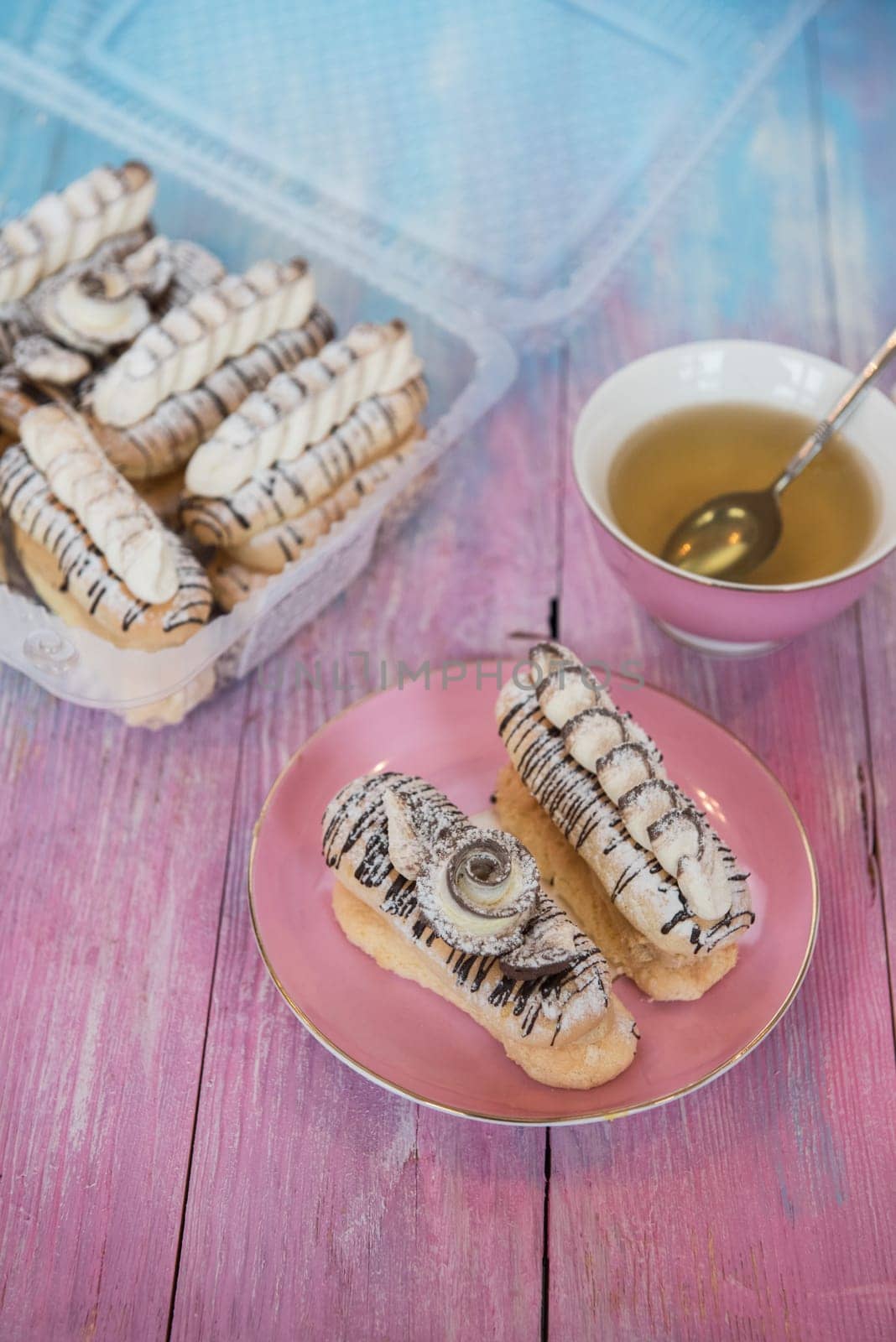 Cakes with tea on gradient color background