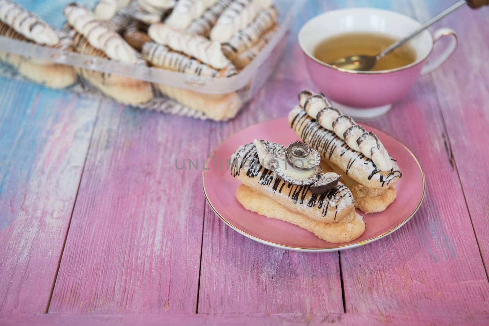 Cakes with tea on gradient color background