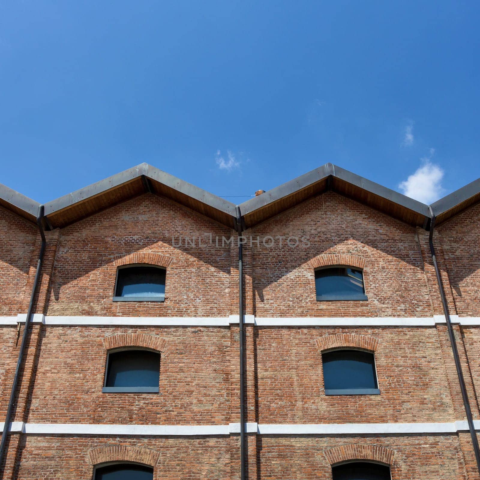 Vintage architecture red brick classical facade. Front view, close up.