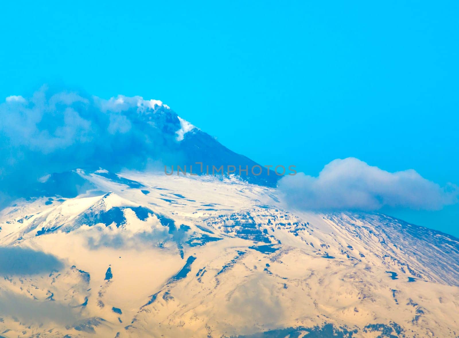snow Etna mountain smoking steam in Sicily, Italy