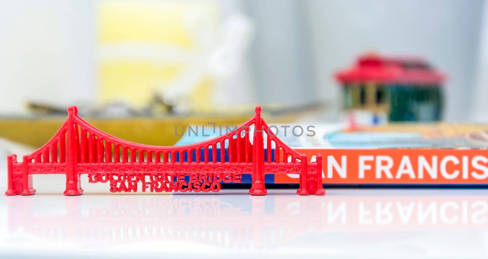 Golden Gate Bridge miniature with San Francisco city guide and a blurred cable car miniature in background