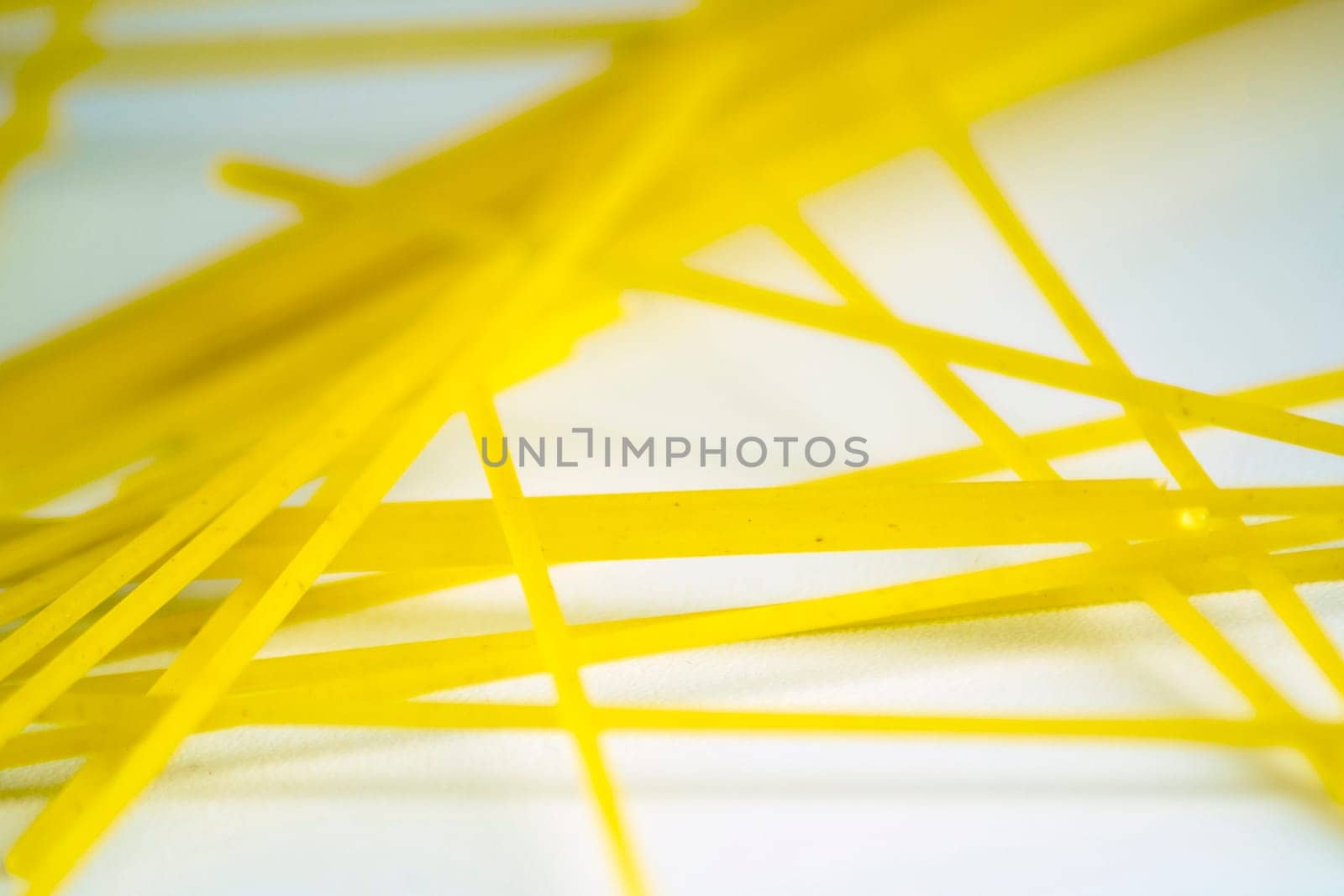 raw spaghetti pasta on a white background. Macro shot