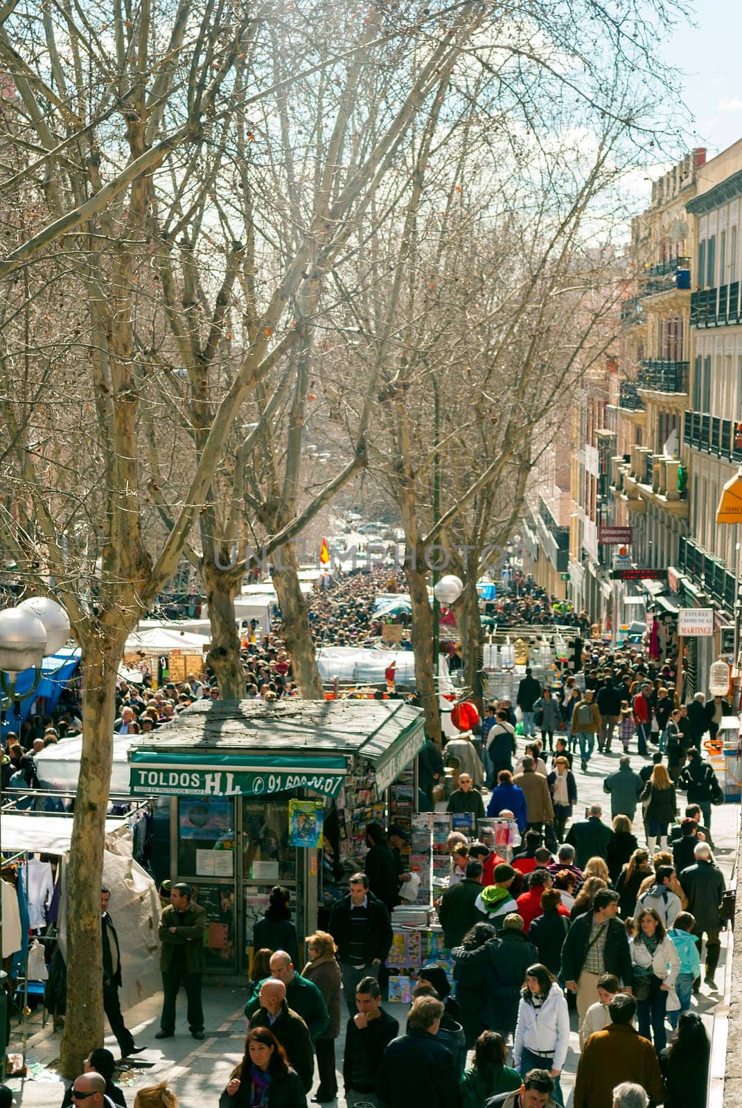 Madrid, Spain, february 28, 2010: Scene from El Rastro flea market in Madrid, Spain. El Rastro is held in La Latina neighborhood every Sunday and it’s the most important market in Madrid.