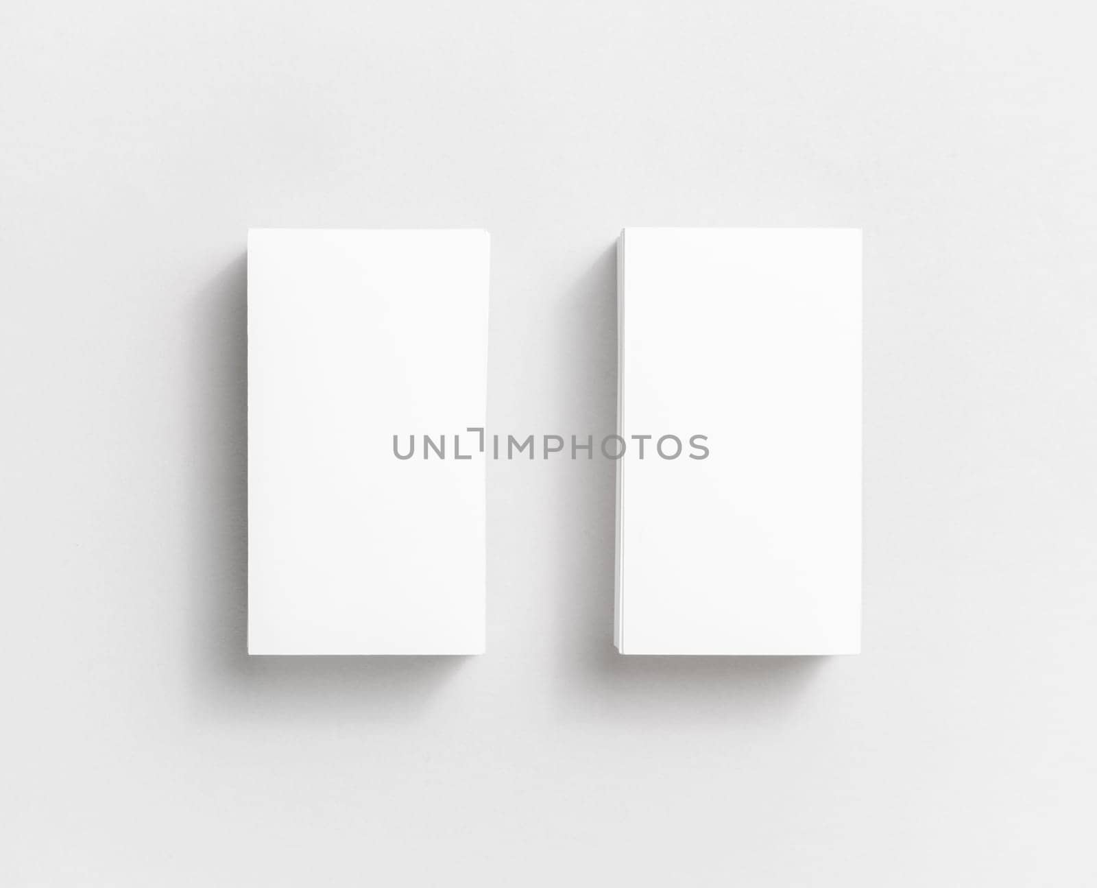 Photo of blank white paper business cards on paper background. Template for ID. Top view.