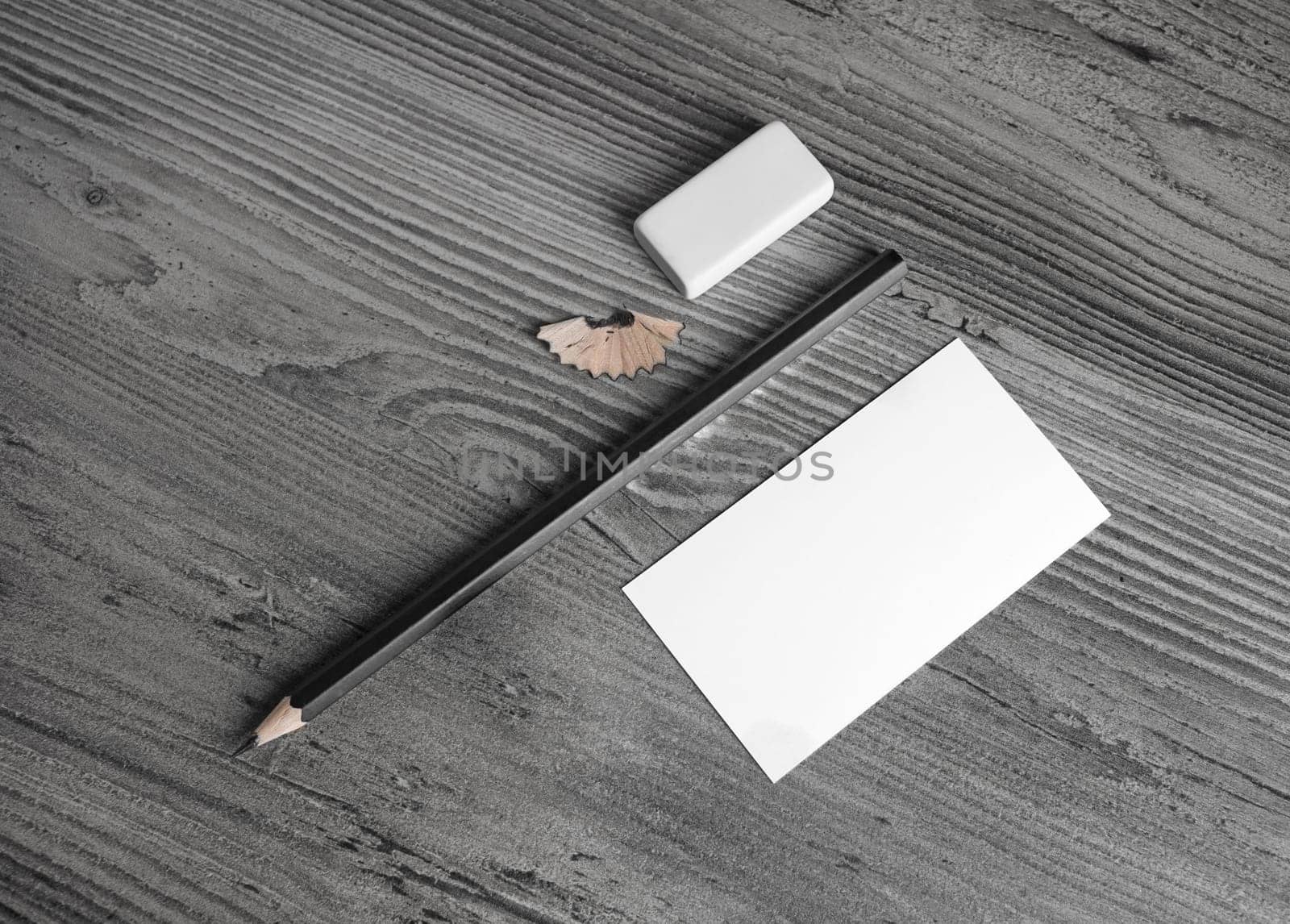 Blank stationery set. Business card, pencil and eraser on wood background. Top view.