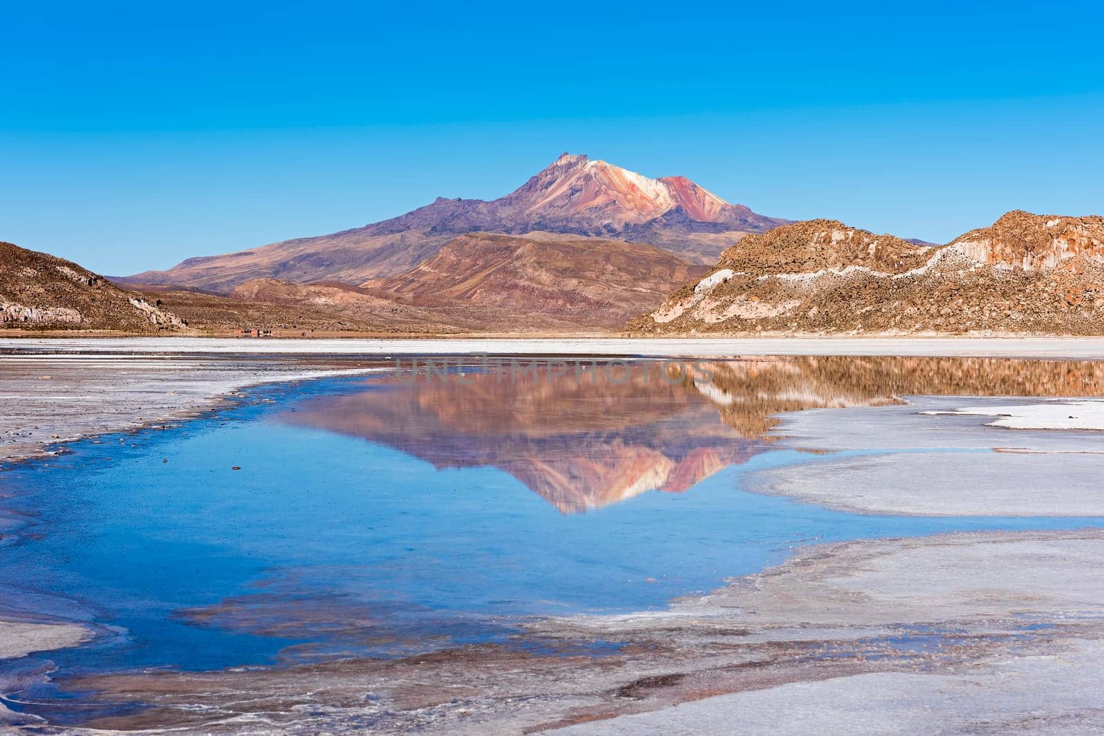 Volcano Cerro Tunupa with reflection in the Salar de Uyuni,Altiplano,3670 m above sea level,Bolivia,South America
