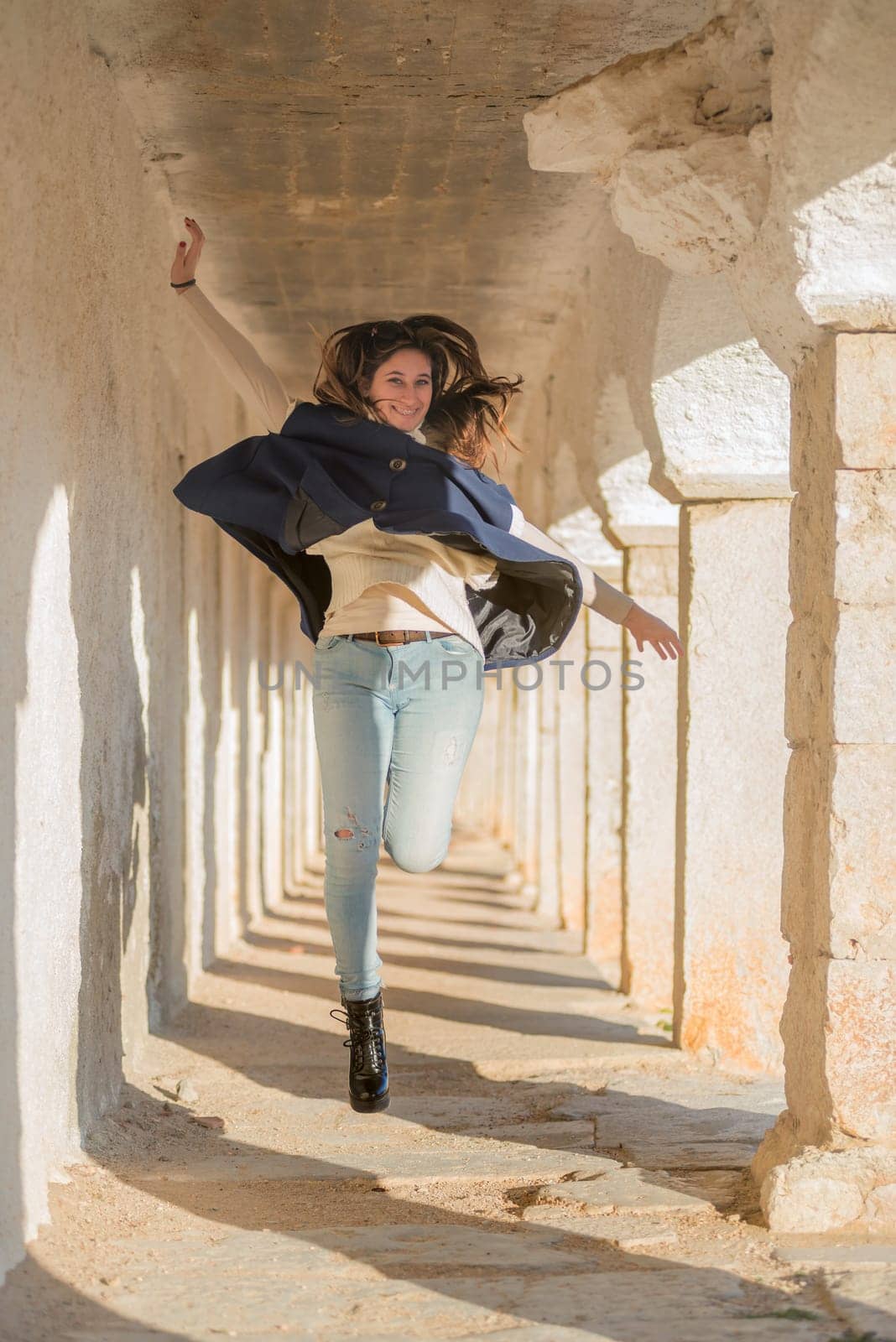 Beautiful and happy young girl jumping outdoors