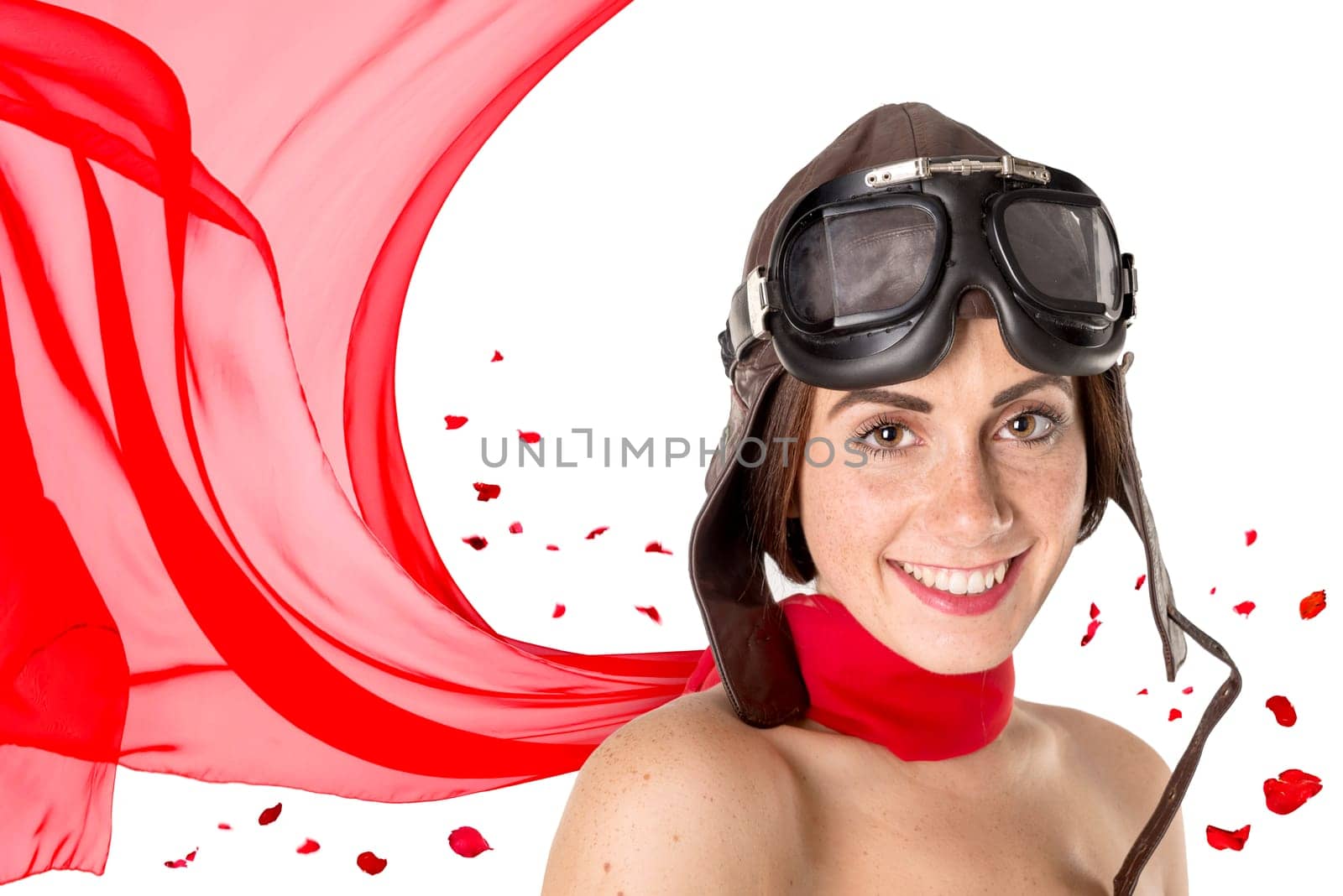 Beautiful girl with helmet and goggles and red rose petals