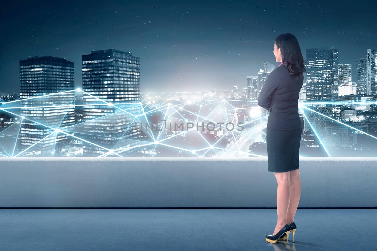 Beautiful asian business woman looking at network connection on the cityscape background