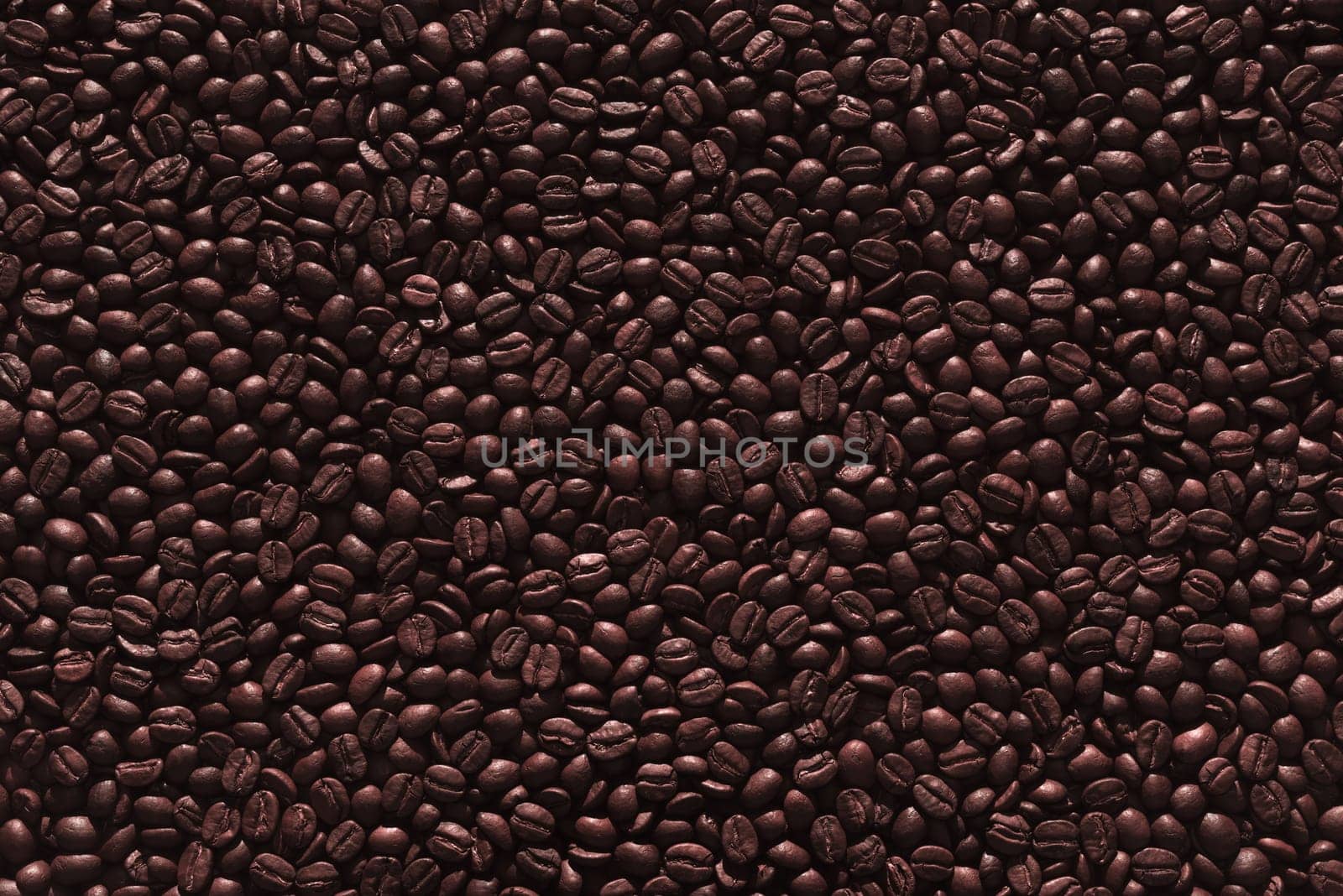 Roasted coffee beans on a flat background.