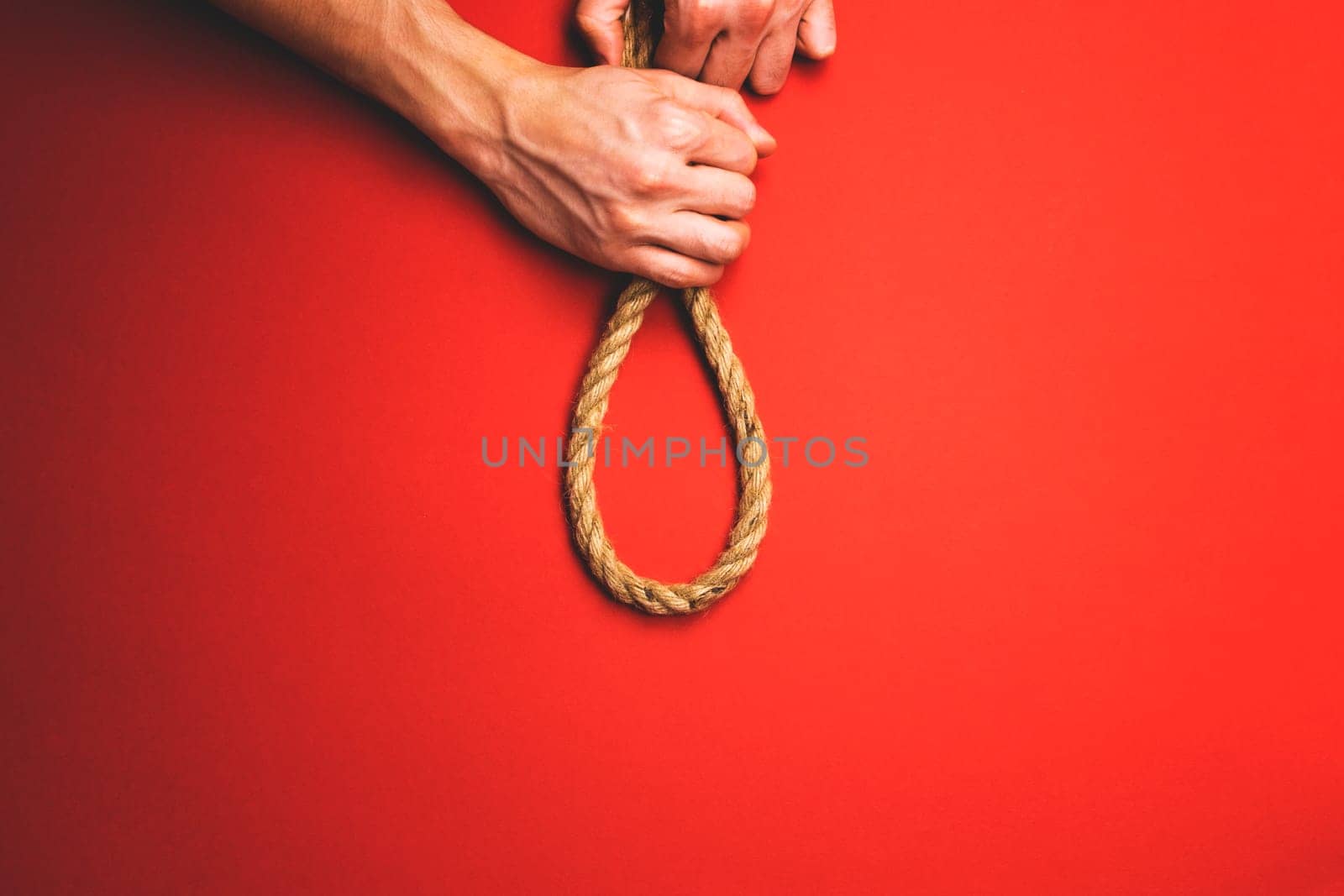 The man tightens the noose.