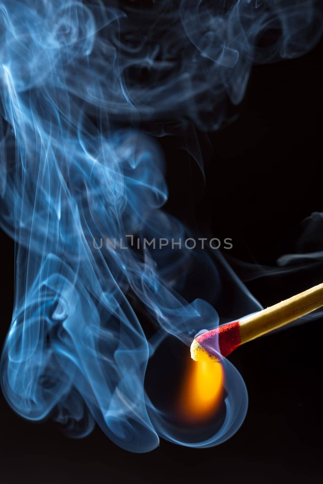 Burning match with blue smoke