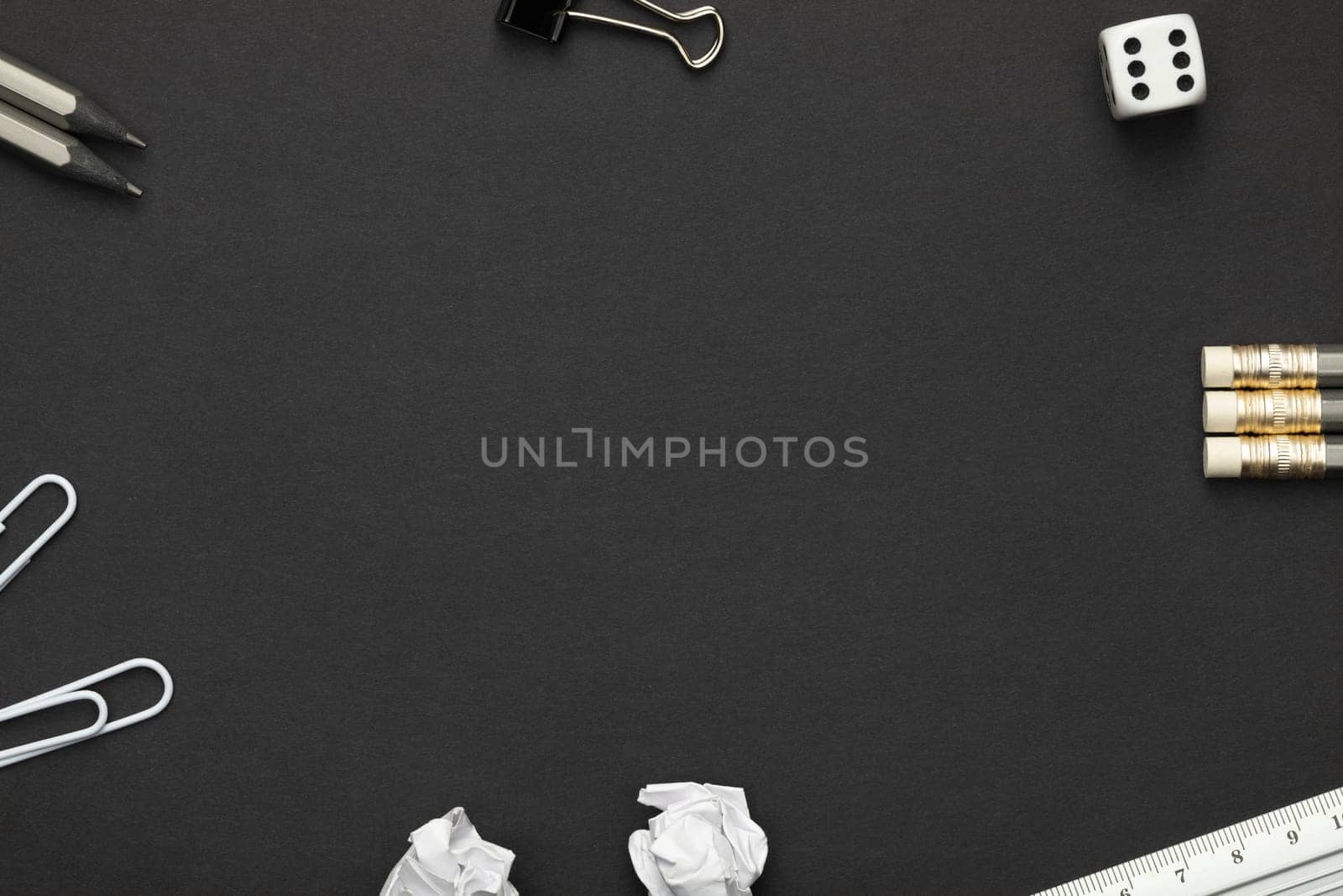 Office accessories on black paper background. Minimal style. Copy space. Top view