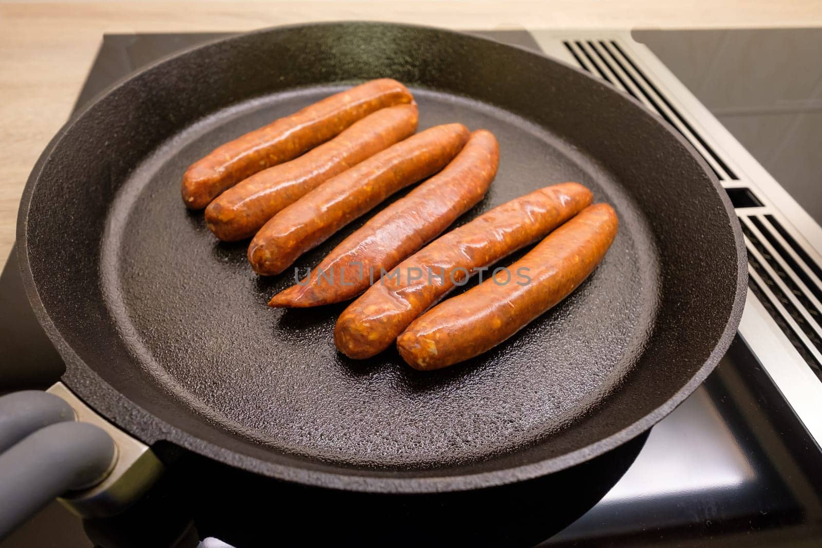 Merguez sausages made from lamb and beef in a frying pan made of cast iron