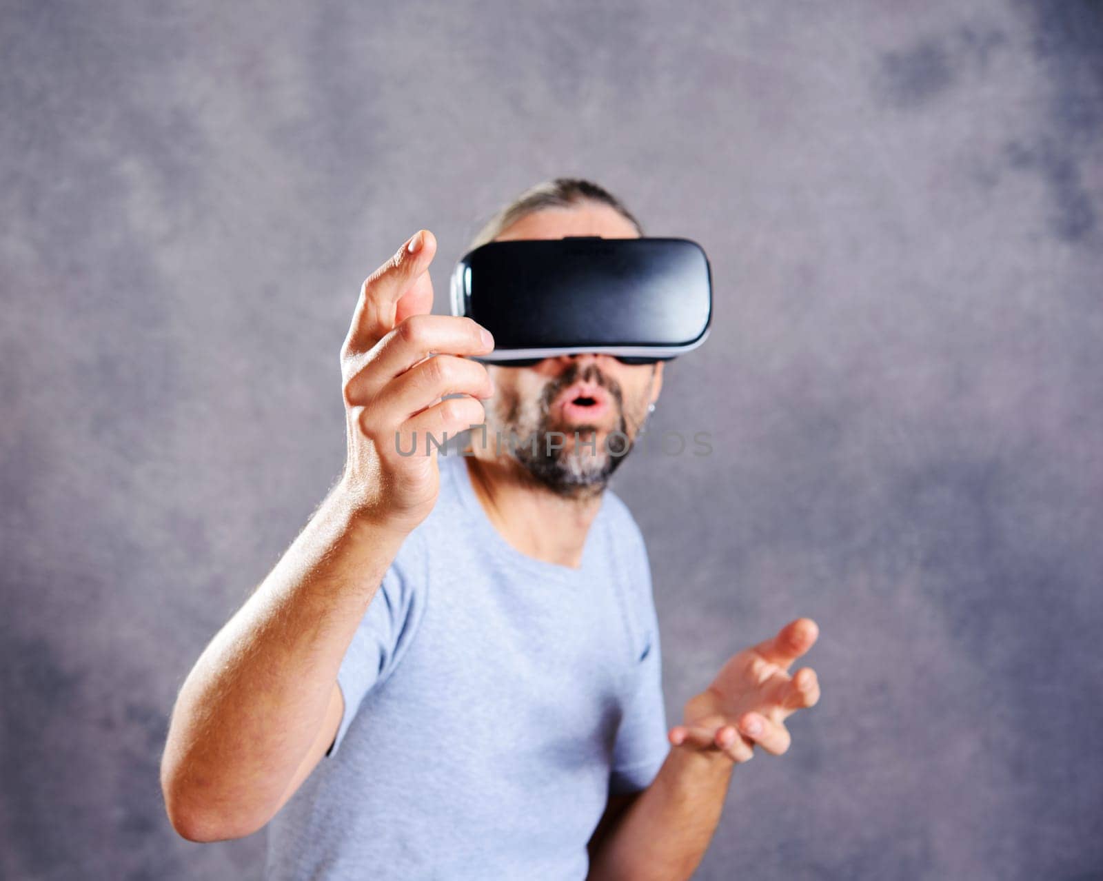 young man with virtual reality glasses looking surprised