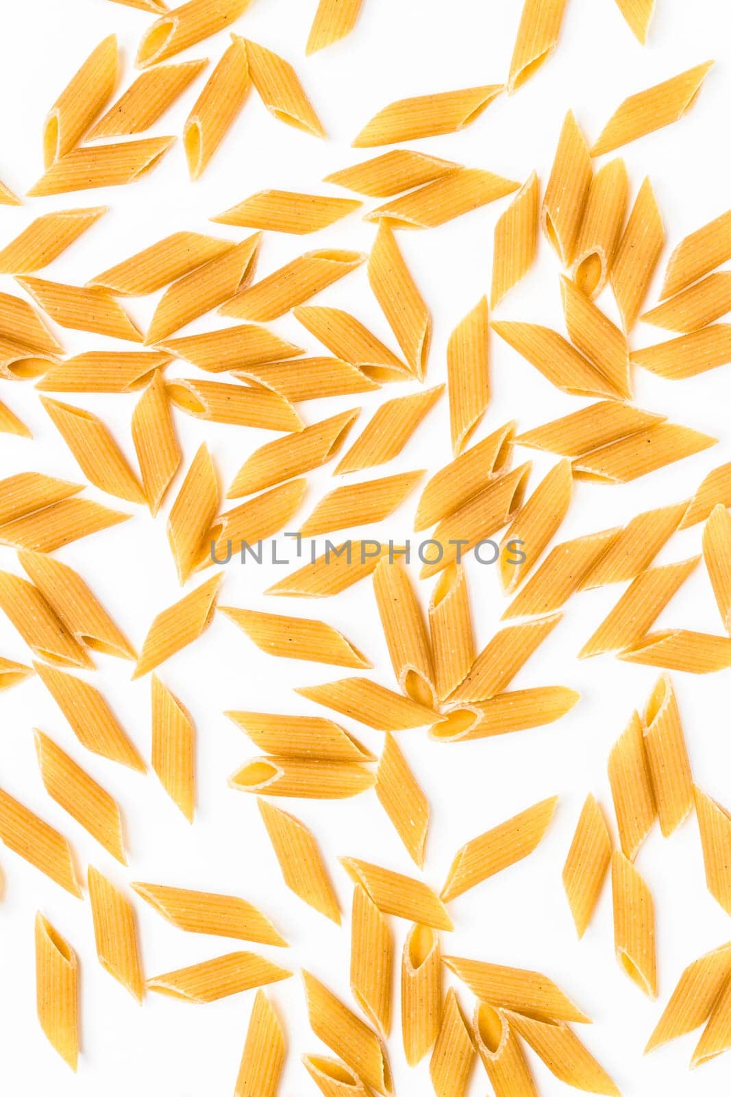 Italian Penne pasta background. Raw food.