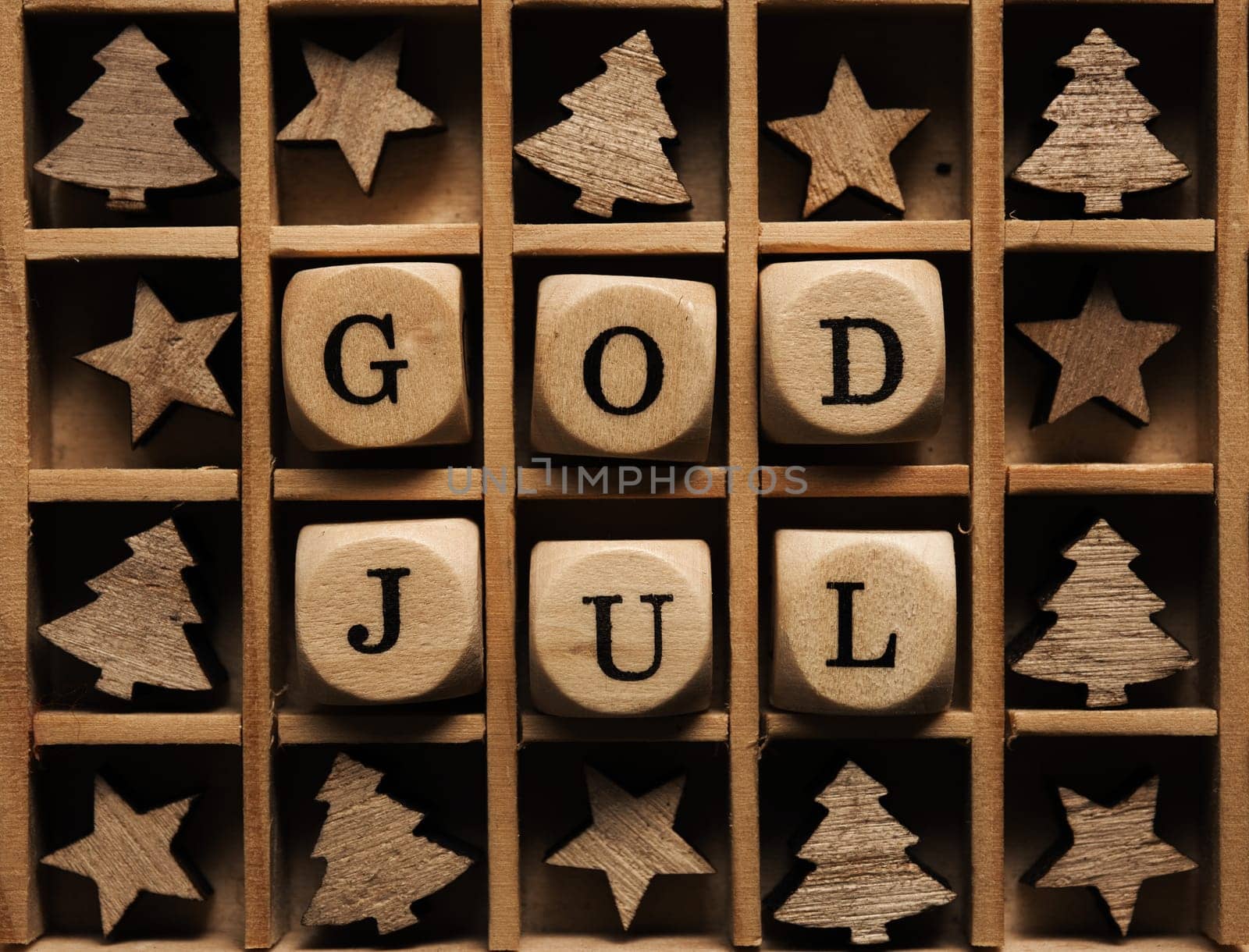 Scandinavian Merry Christmas with wooden dices and the words God Jul