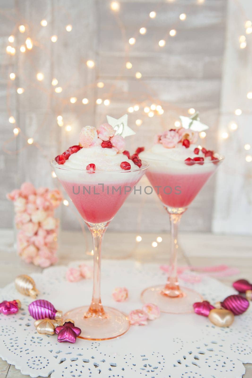 Cream dessert with popcorn and pomegranate in martini glass