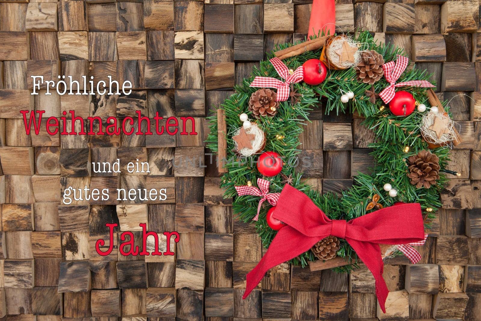 Traditional wreath with decoration for Christmas against a rustic wooden background