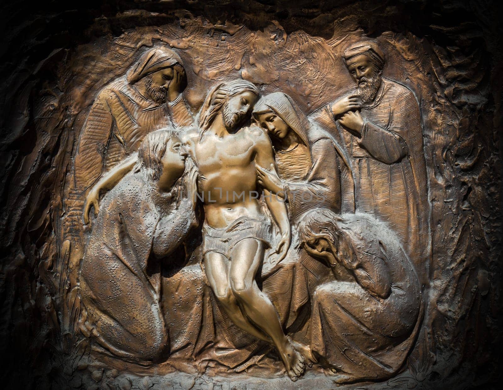 Bronze wall engraving scene depicting the Lamentation of Christ
