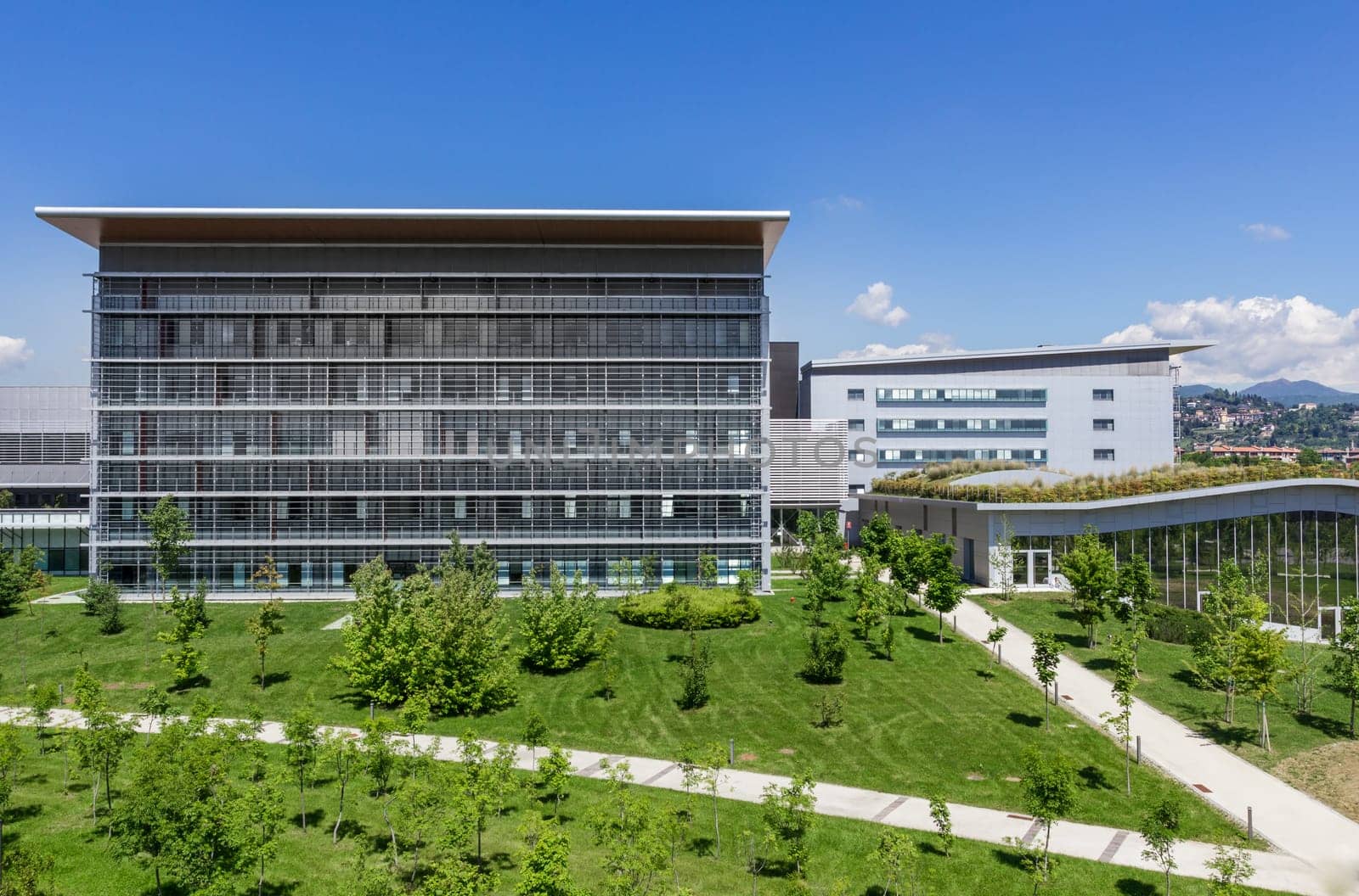 Bergamo, Italy - modern hospital with blue sky, surrounded by trees