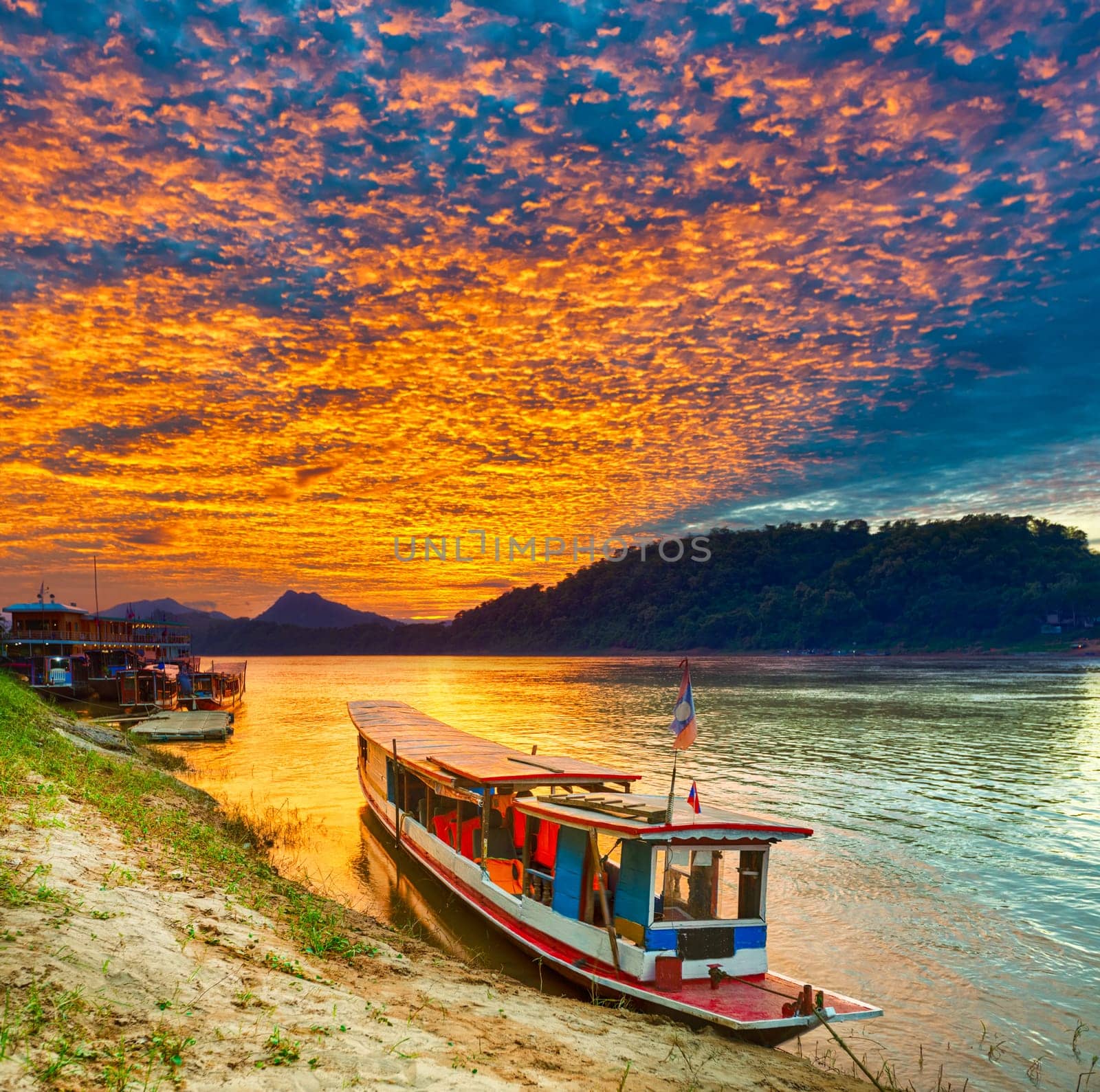 Touristic boat at sunset time. Beautiful landscape. Luang Prabang. Laos.