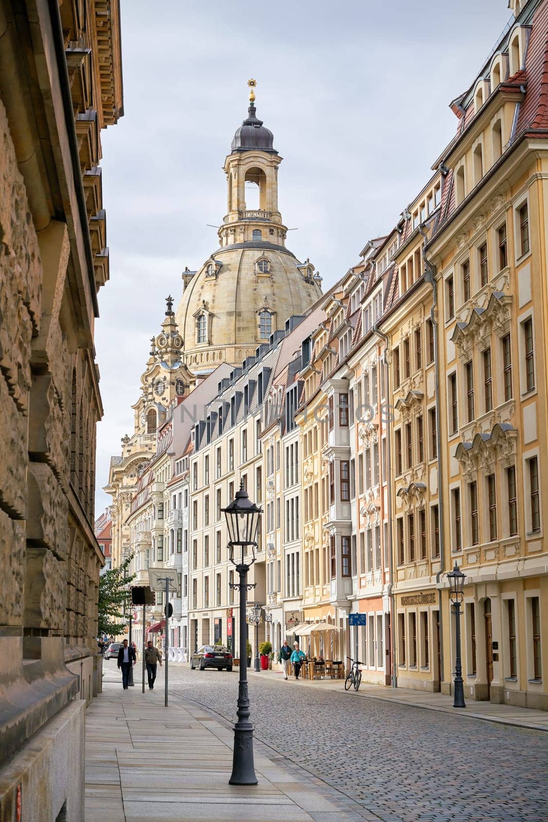Street in the old town of Dresden with the rebuilt Frauenkirche in the background