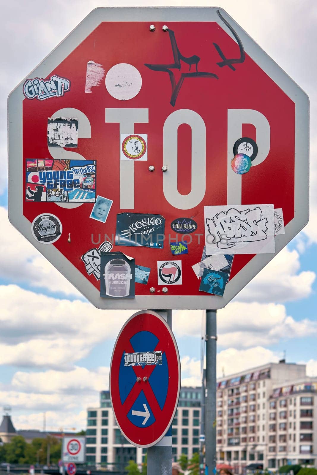 Sticker-covered stop sign on the roadside in downtown Berlin