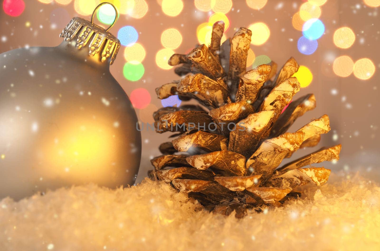 Colorful romantic Christmas background with a pine cone in snow