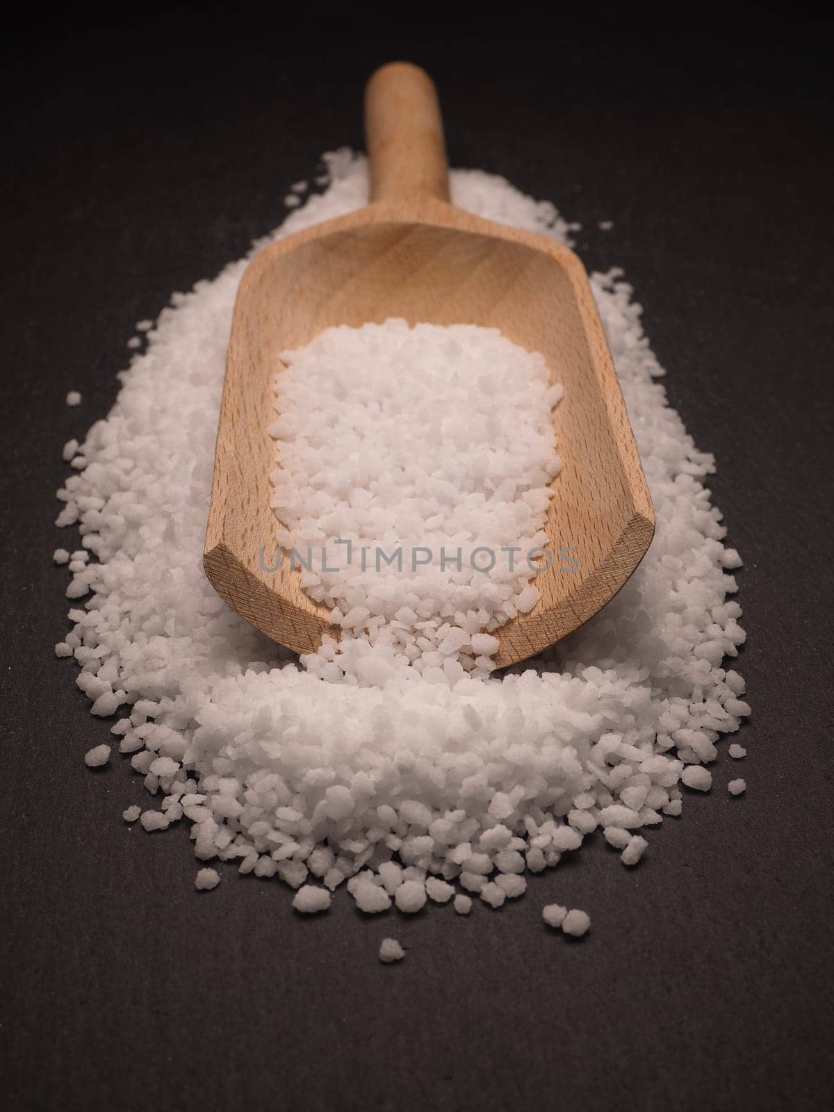 Organic salt on a dark slate board, food concepts