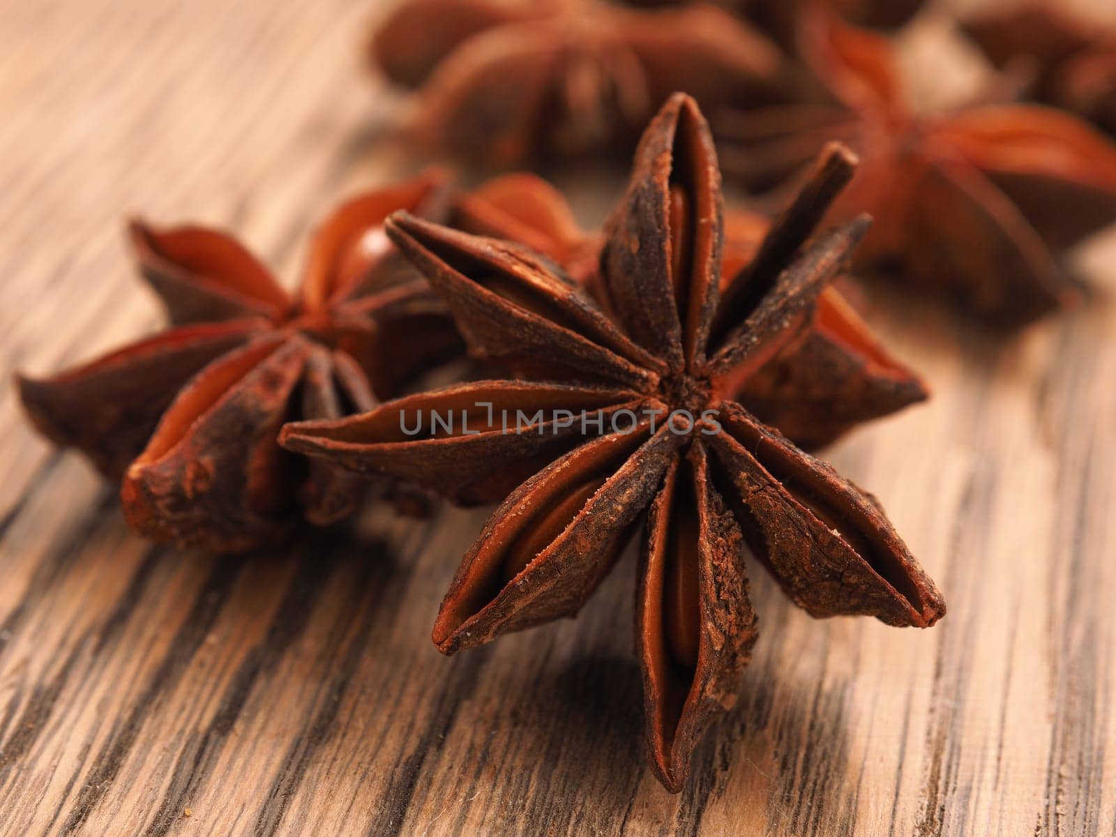 Close up of star anise on a rustic wooden kitchen table, Christmas herbs