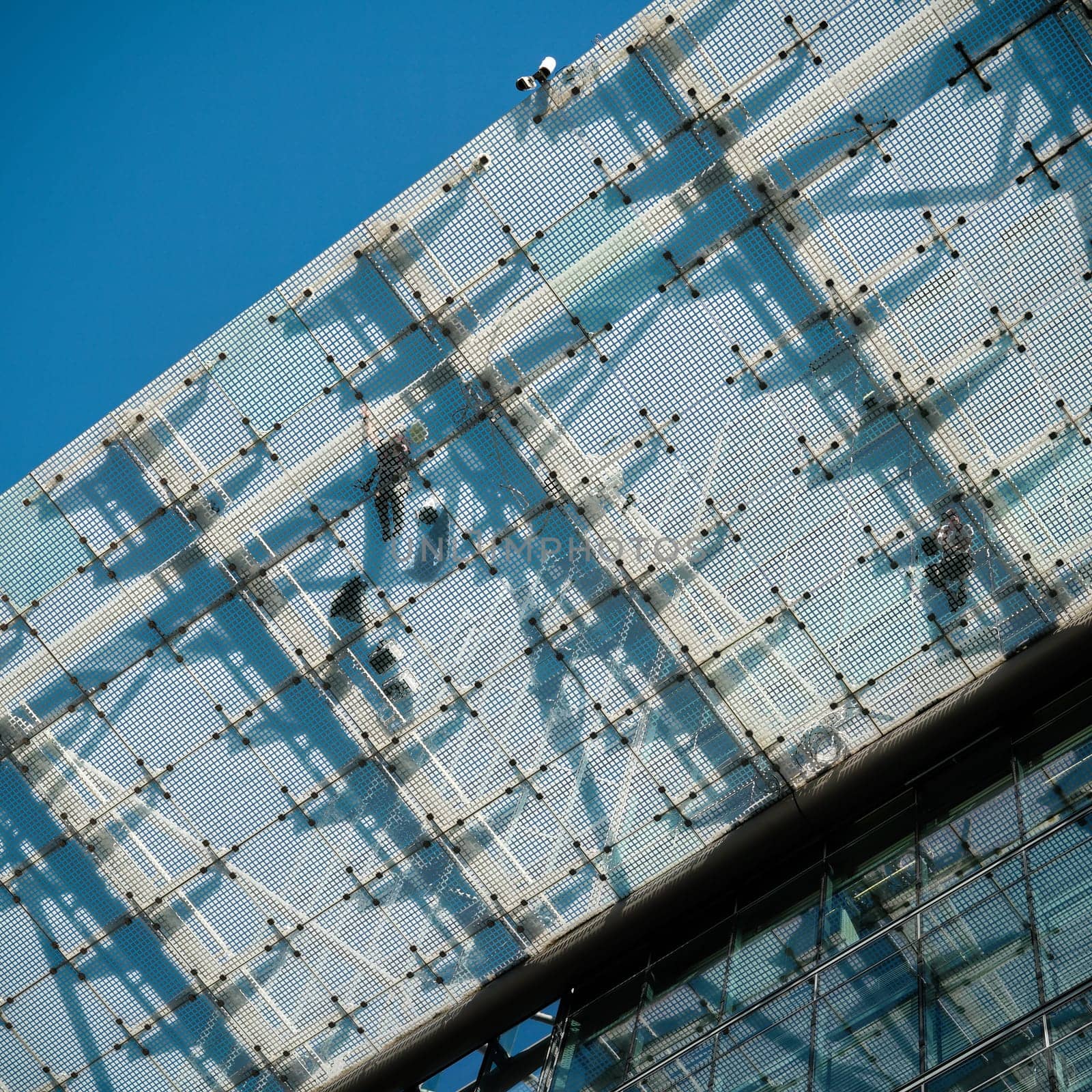 Fitters on a glass roof on a construction site in Berlin