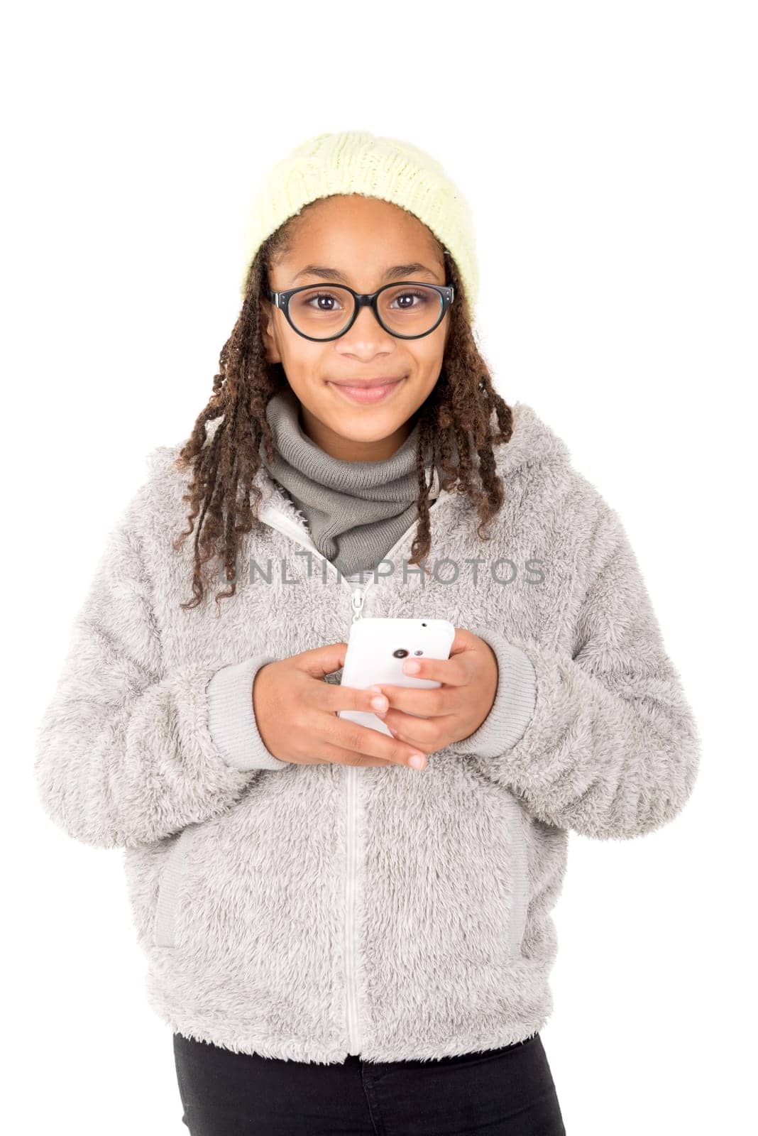 Young girl posing with cellphone isolated in white