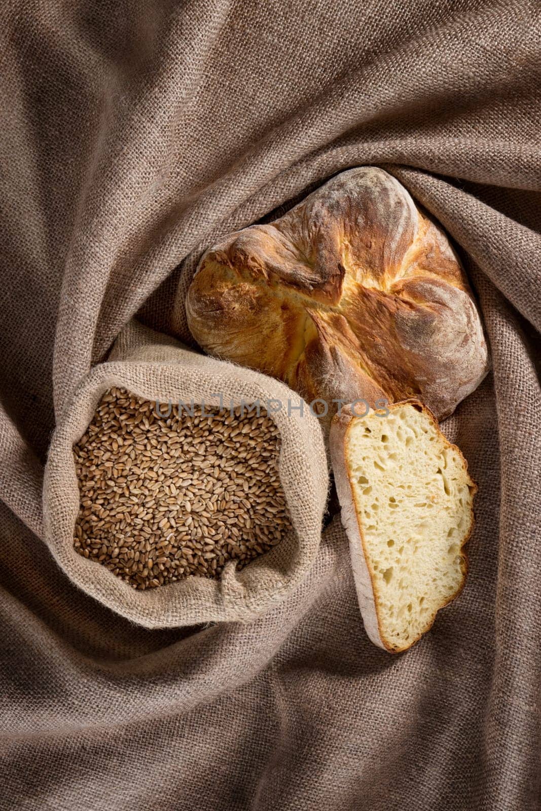 Bread and a bag of grains placed on a sackcloth