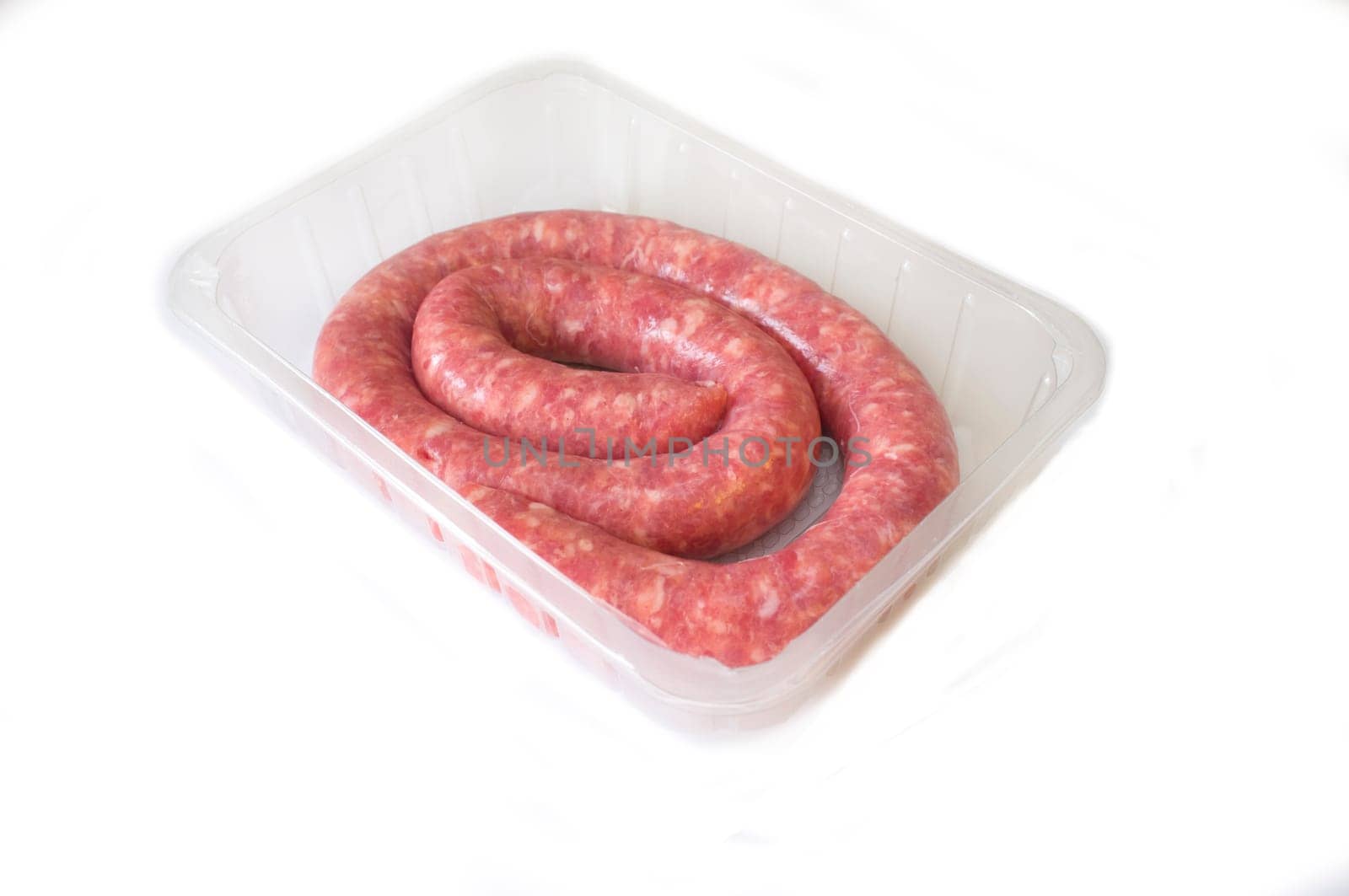 Rolled uncooked botifarra or Catalan sausage on the package. Isolated on white