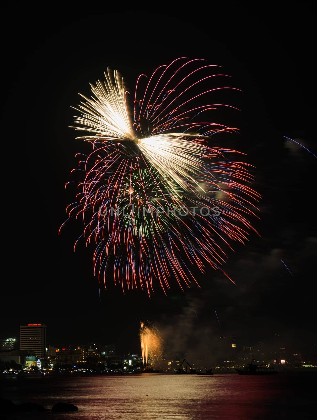 Colorful firework at Pattaya coast with cityscape background, Thailand