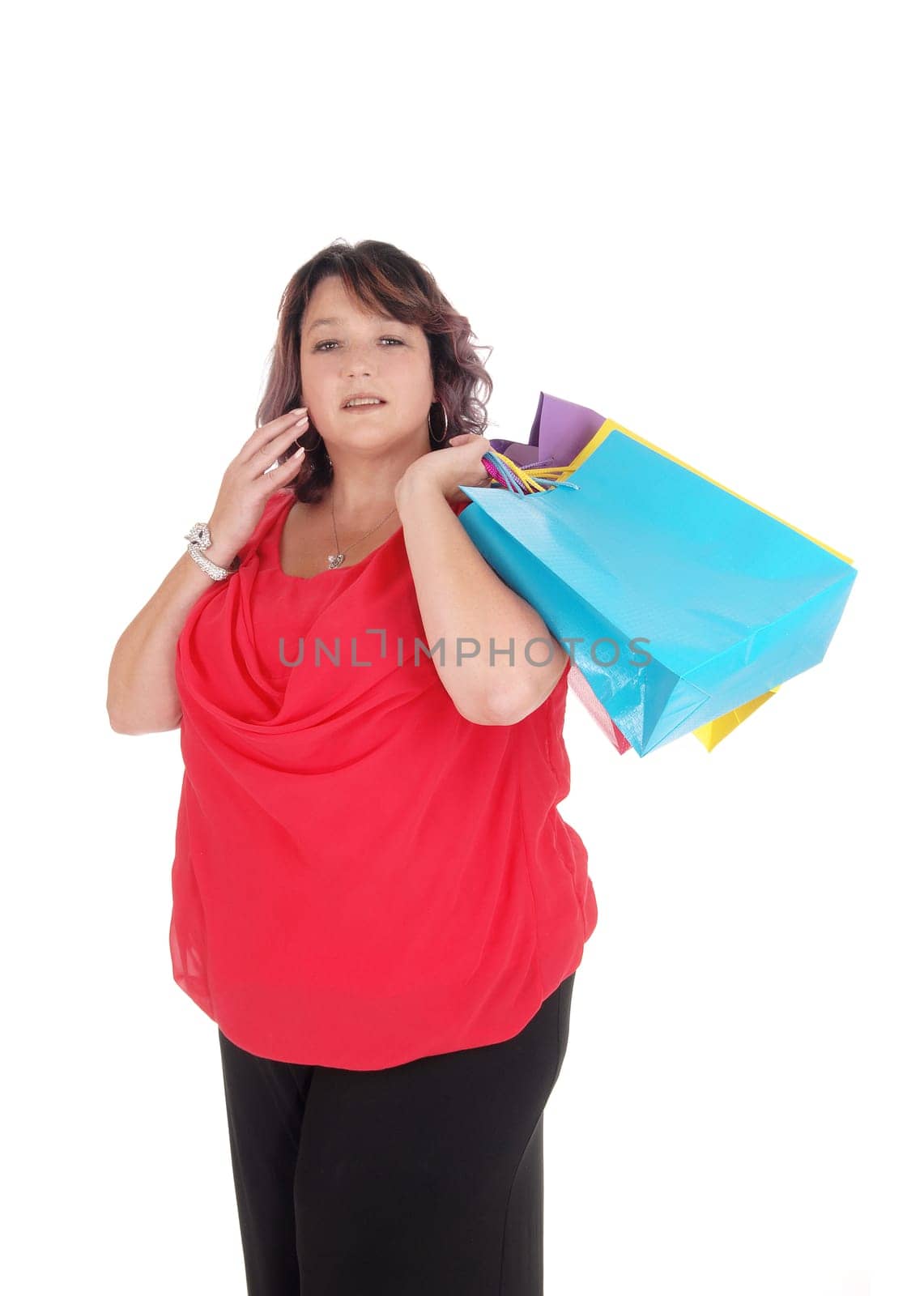 A woman in a red blouse holding her shopping bags standing.isolated for white background.