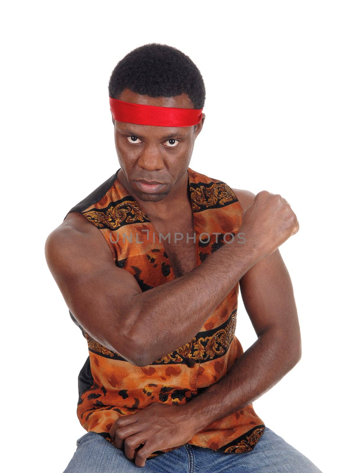 A handsome African American man sitting in a vest making a fist and .looking angry, isolated for white background.