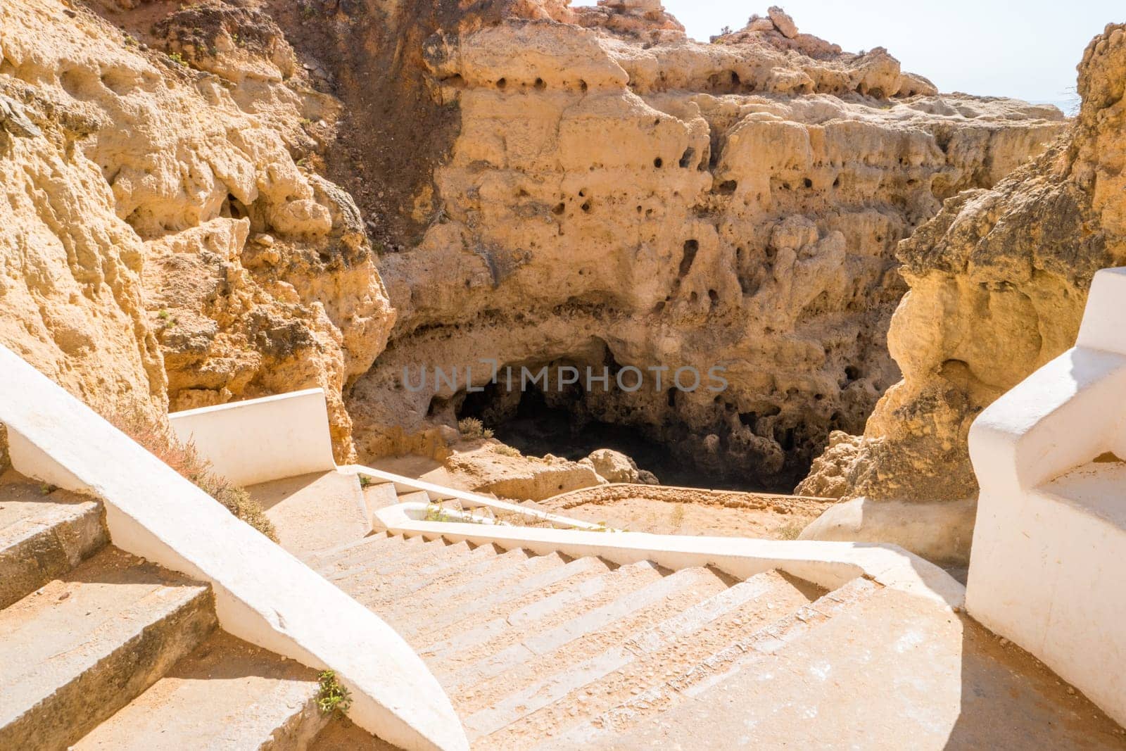 A pool of natural sea water between sandstone cliffs at Algar Seco. Carvoeiro Algarve Portugal.