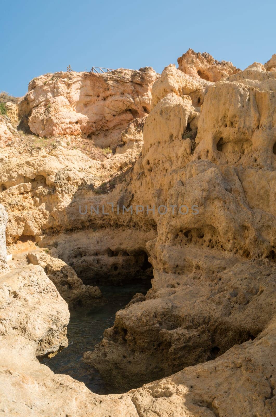 A pool of natural sea water between sandstone cliffs at Algar Seco. Carvoeiro Algarve Portugal.