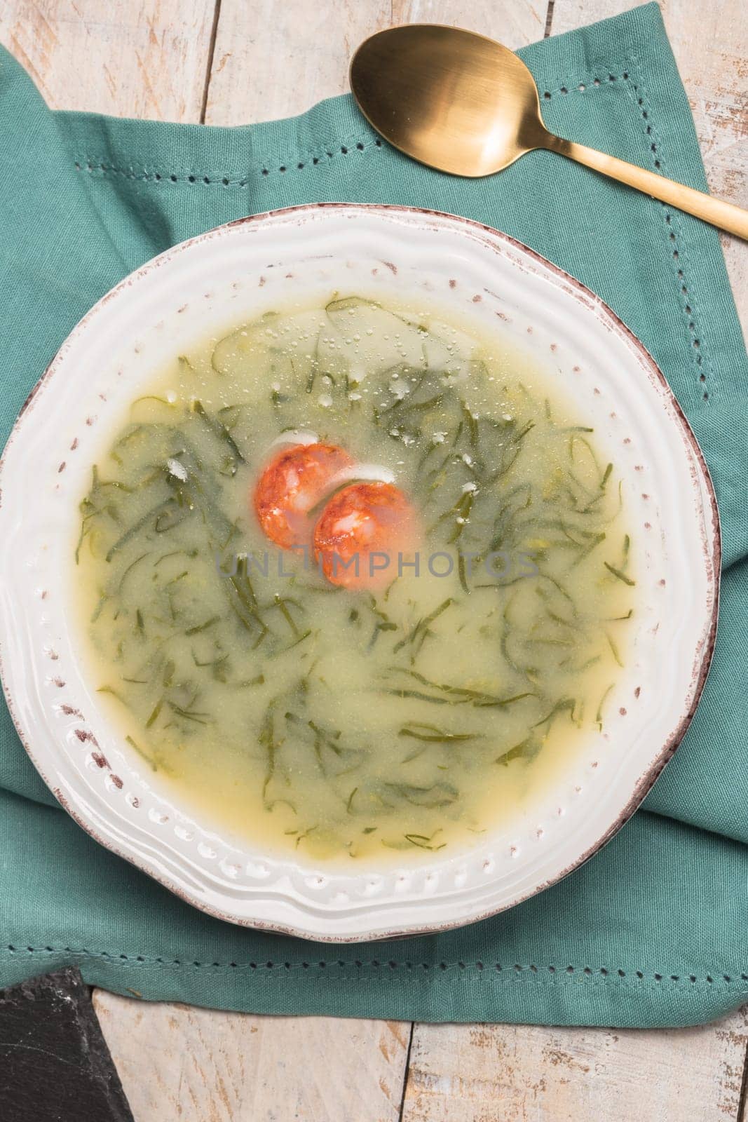 Caldo verde popular soup in Portuguese cuisine. traditional ingredients for caldo verde are potatoes, collard greens , olive oil and salt. Additionally garlic or onion may be added.