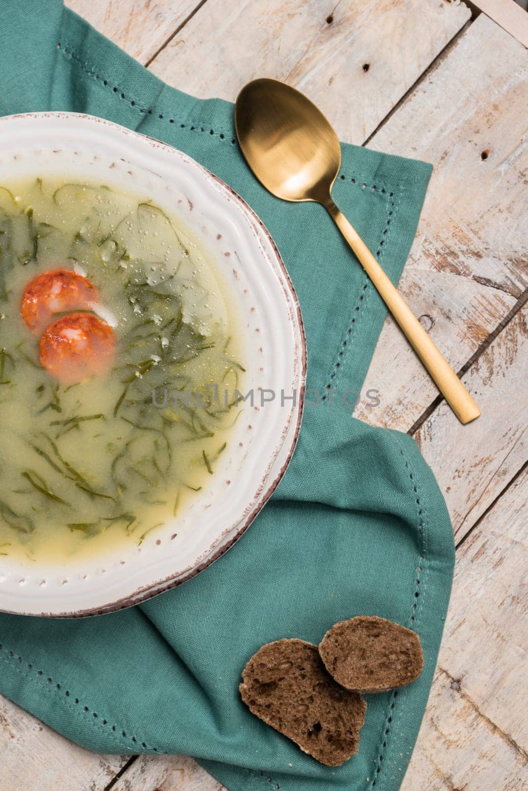 Caldo verde popular soup in Portuguese cuisine. traditional ingredients for caldo verde are potatoes, collard greens , olive oil and salt. Additionally garlic or onion may be added.