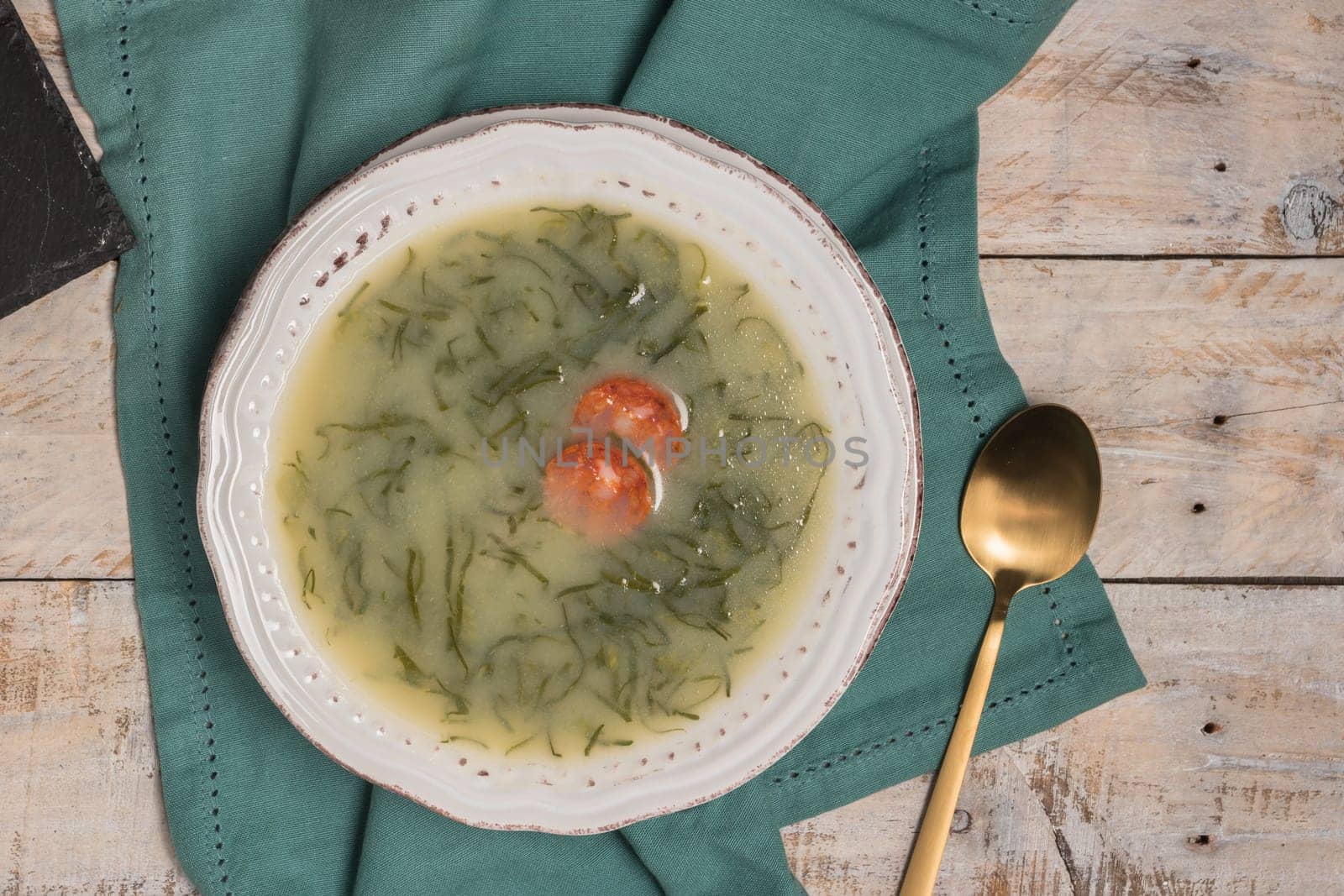 Caldo verde popular soup in Portuguese cuisine. traditional ingredients for caldo verde are potatoes, collard greens , olive oil and salt. Additionally garlic or onion may be added.