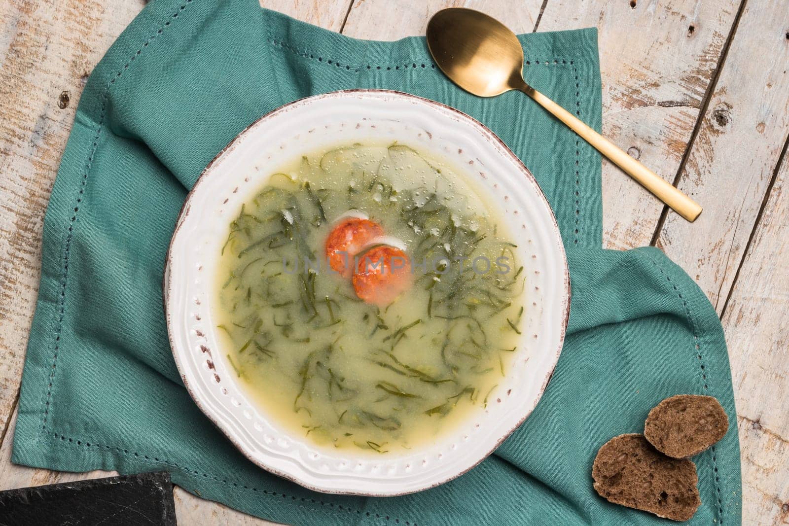 Caldo verde popular soup in Portuguese cuisine. traditional ingredients for caldo verde are potatoes, collard greens , olive oil and salt. Additionally garlic or onion may be added.