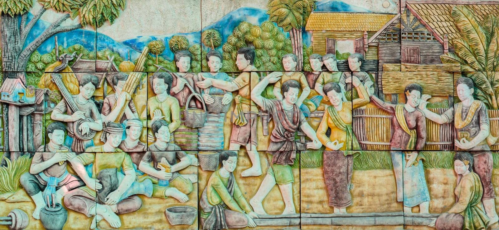 Thai stucco art of traditional Thai bamboo clapping folk dance, Thailand